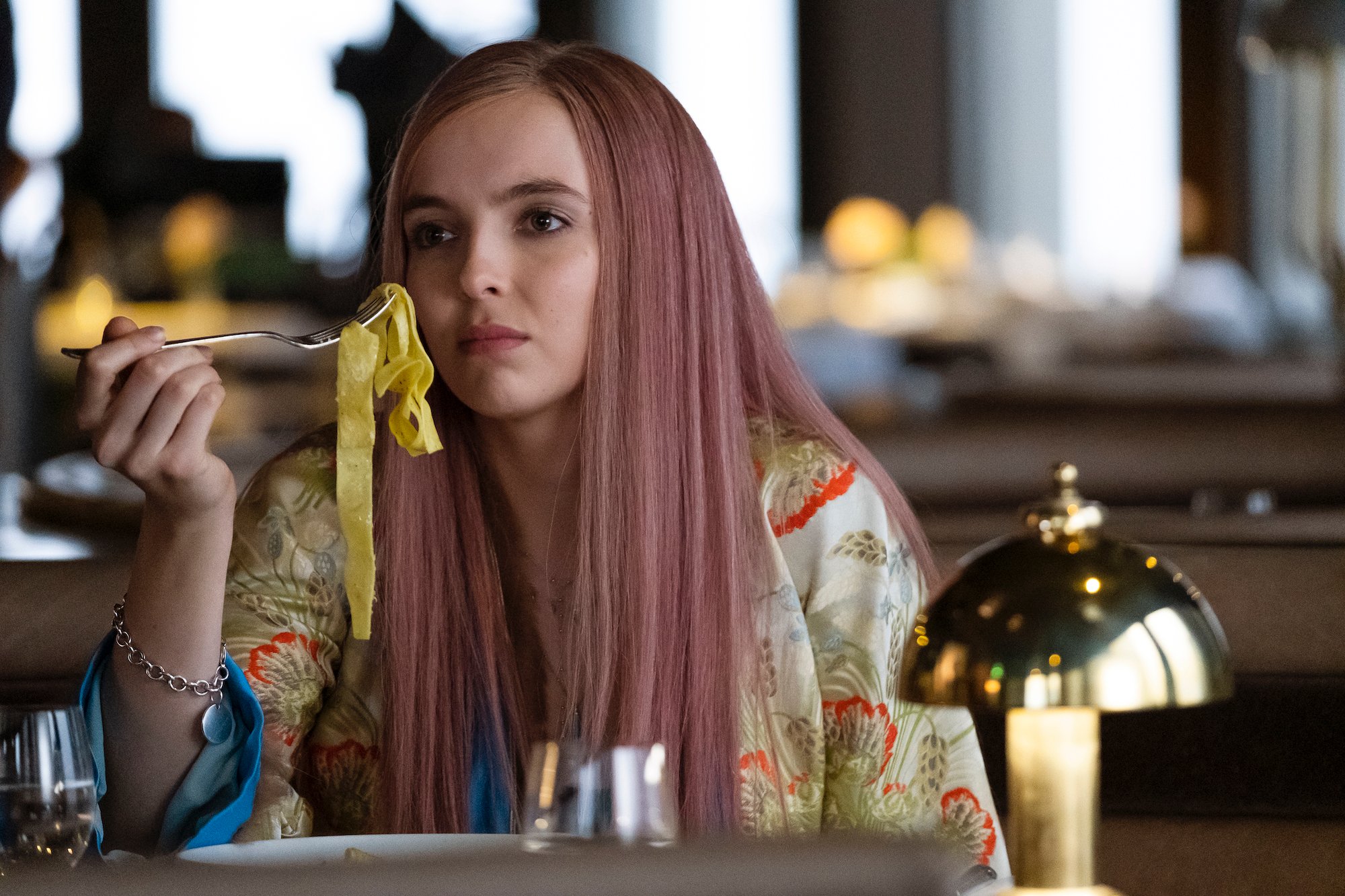 Jodie Comer as Villanelle in Season 2, eating pasta.