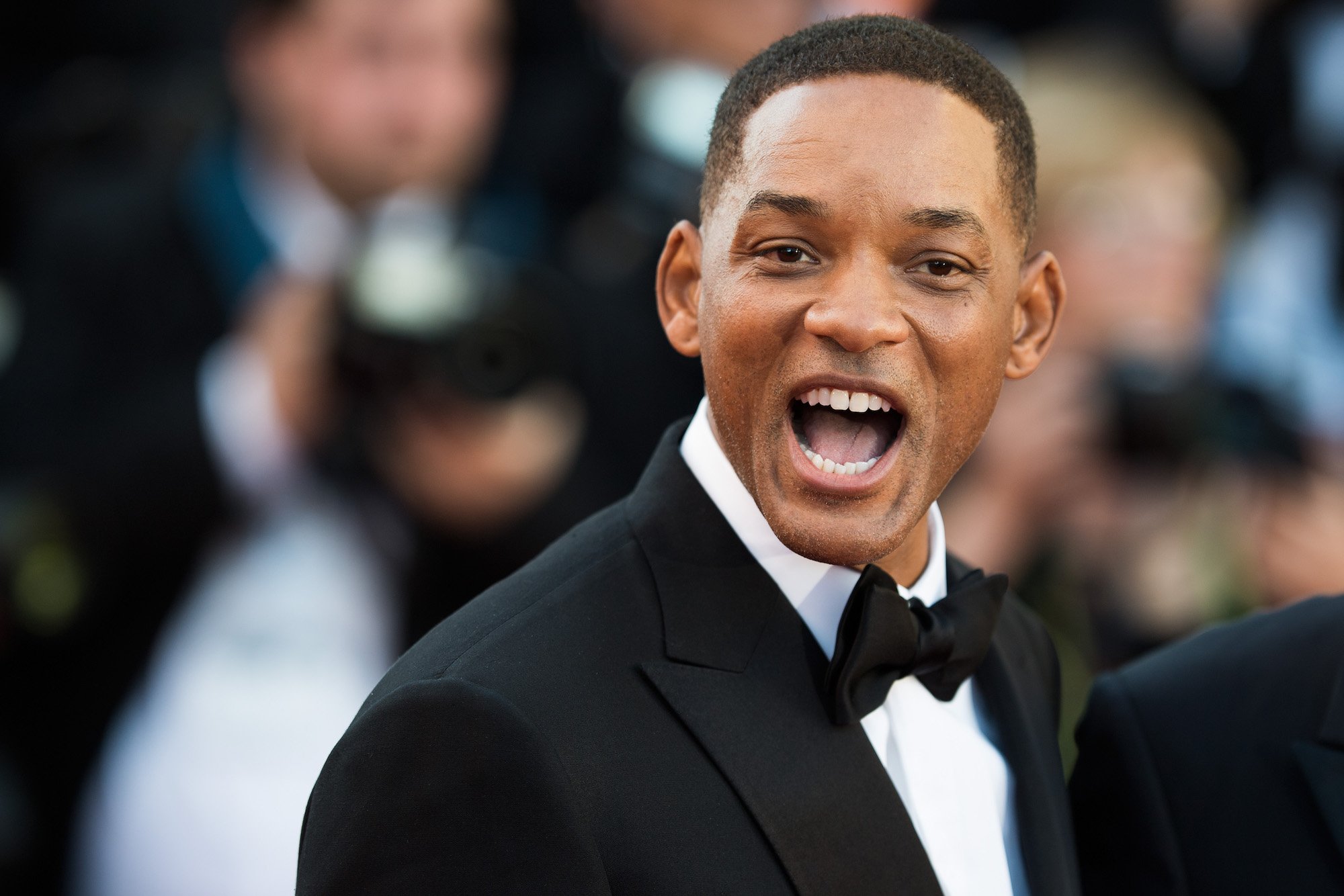 Will Smith smiling open mouthed at the camera
