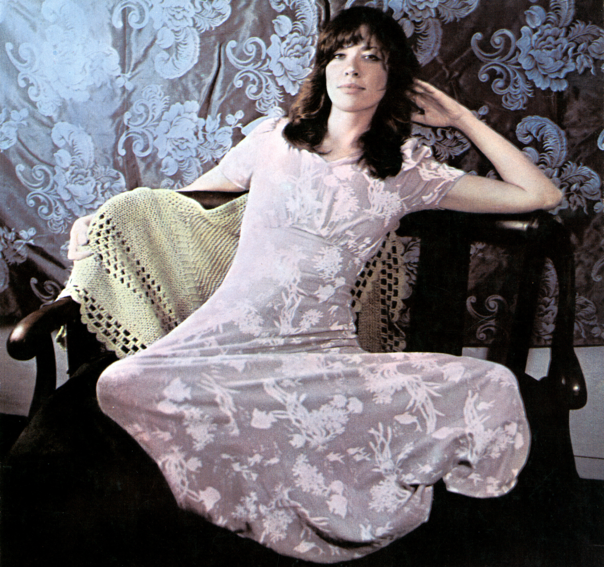Carly Simon sitting on a chair