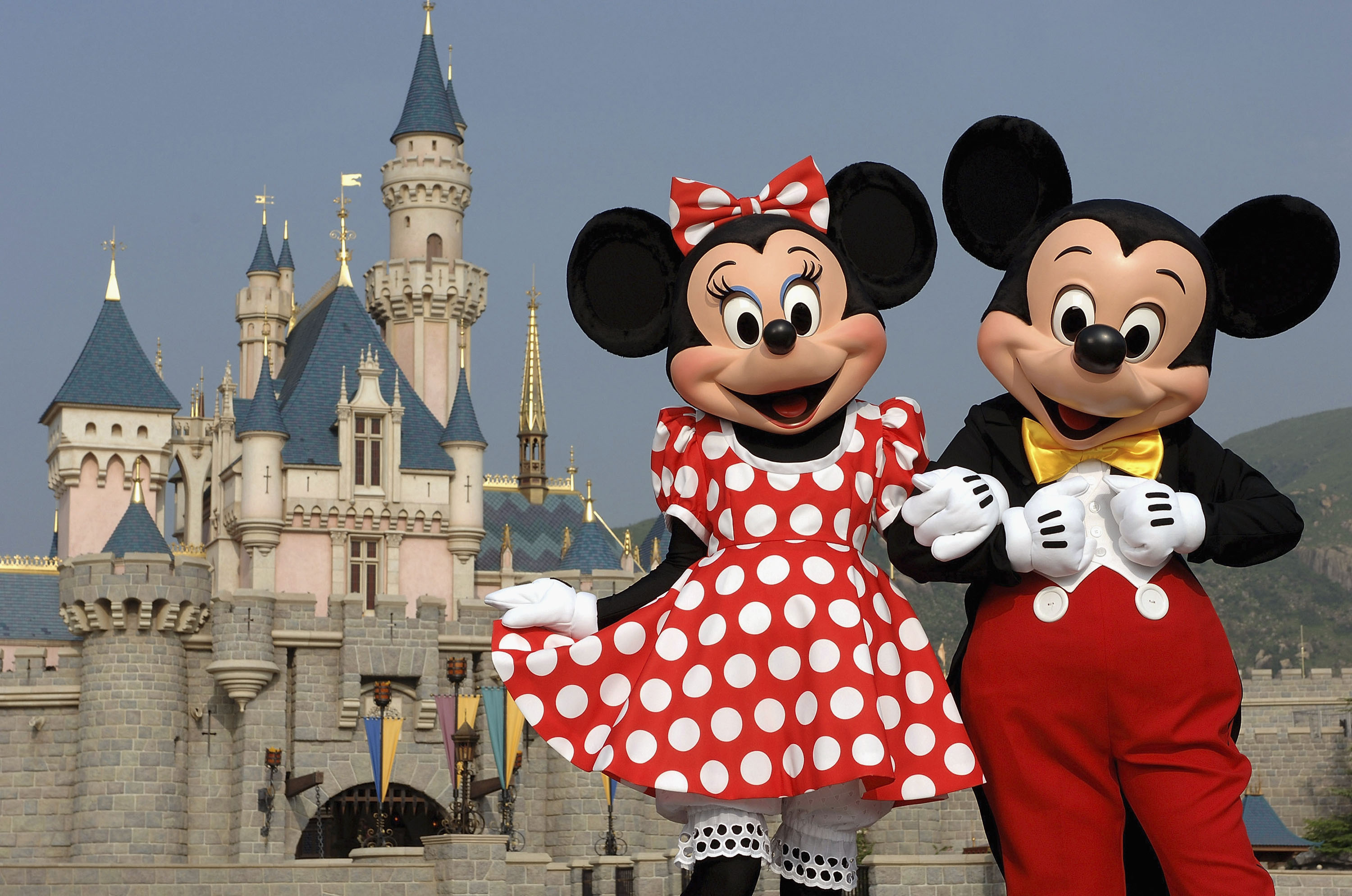 Mickey and Minnie Mouse near a castle