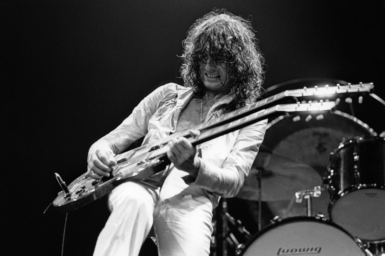 Jimmy Page playing guitar on stage, 1977