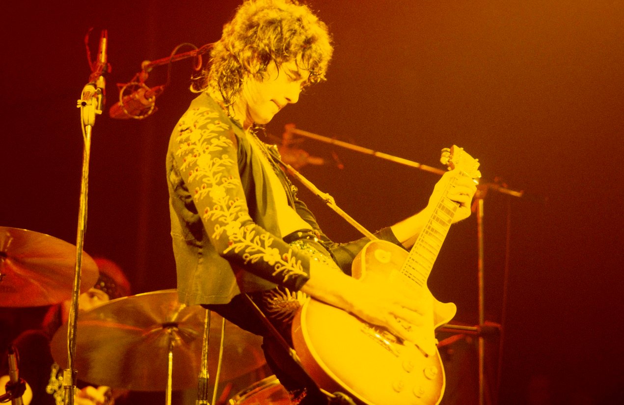 Jimmy Page playing guitar in the stage spotlight, 1973