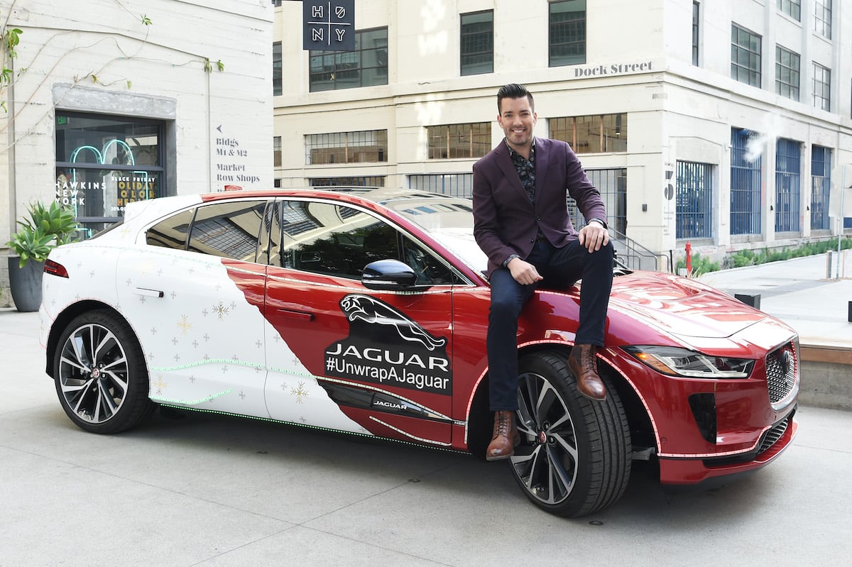 Jonathan Scott, host of HGTV'S "Property Brothers," sits on a car