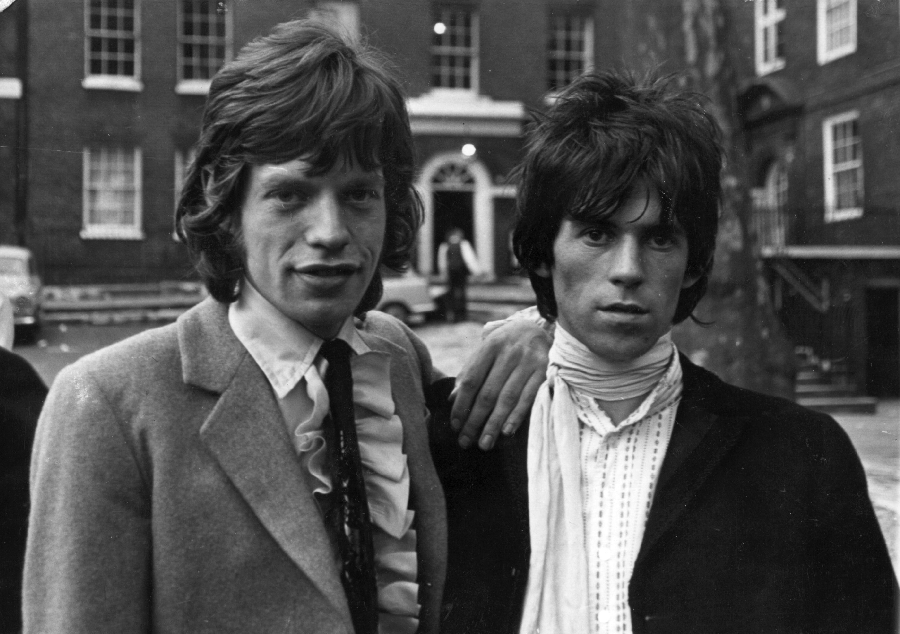 Mick Jagger with his hands on Keith Richards