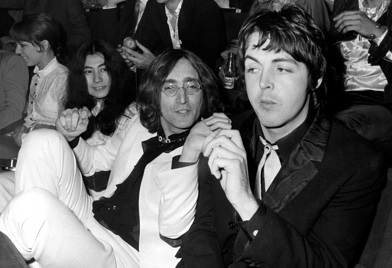 Yoko Ono, John Lennon and Paul McCartney sitting in a movie theater