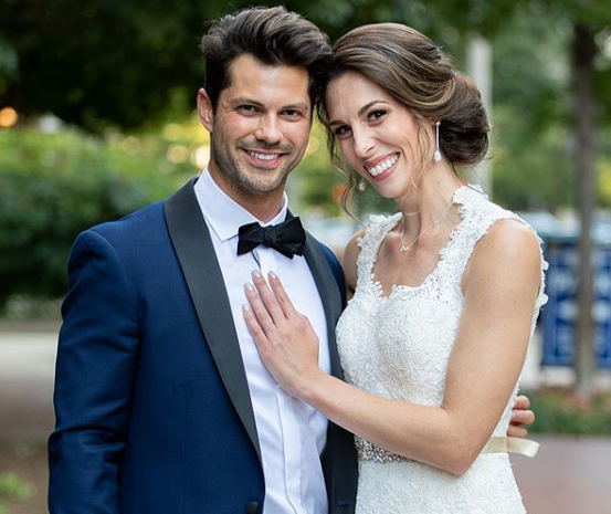 Married at First Sight couple Mindy Shiben and Zach Justice pose in wedding attire.