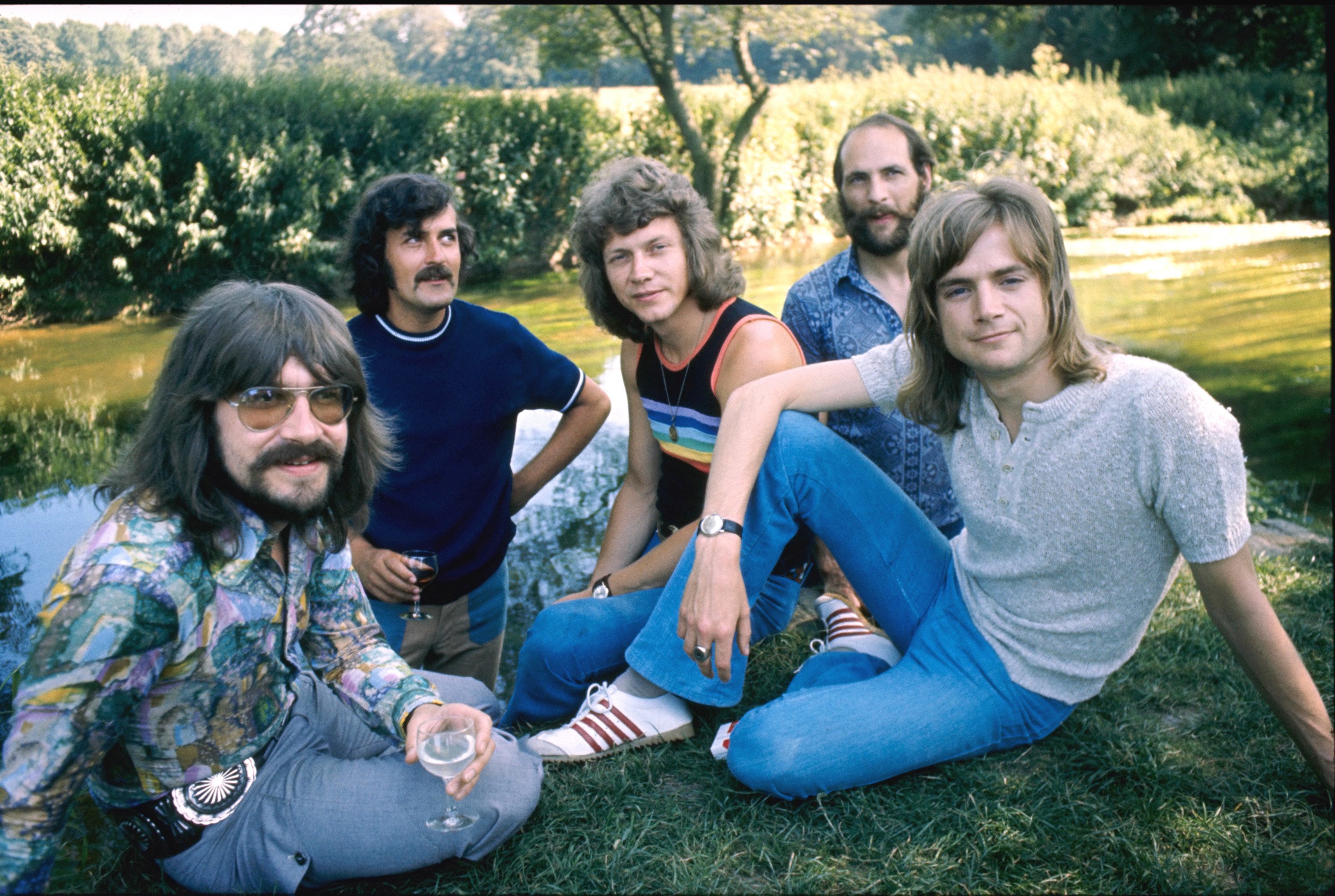 The Moody Blues sitting on the grass