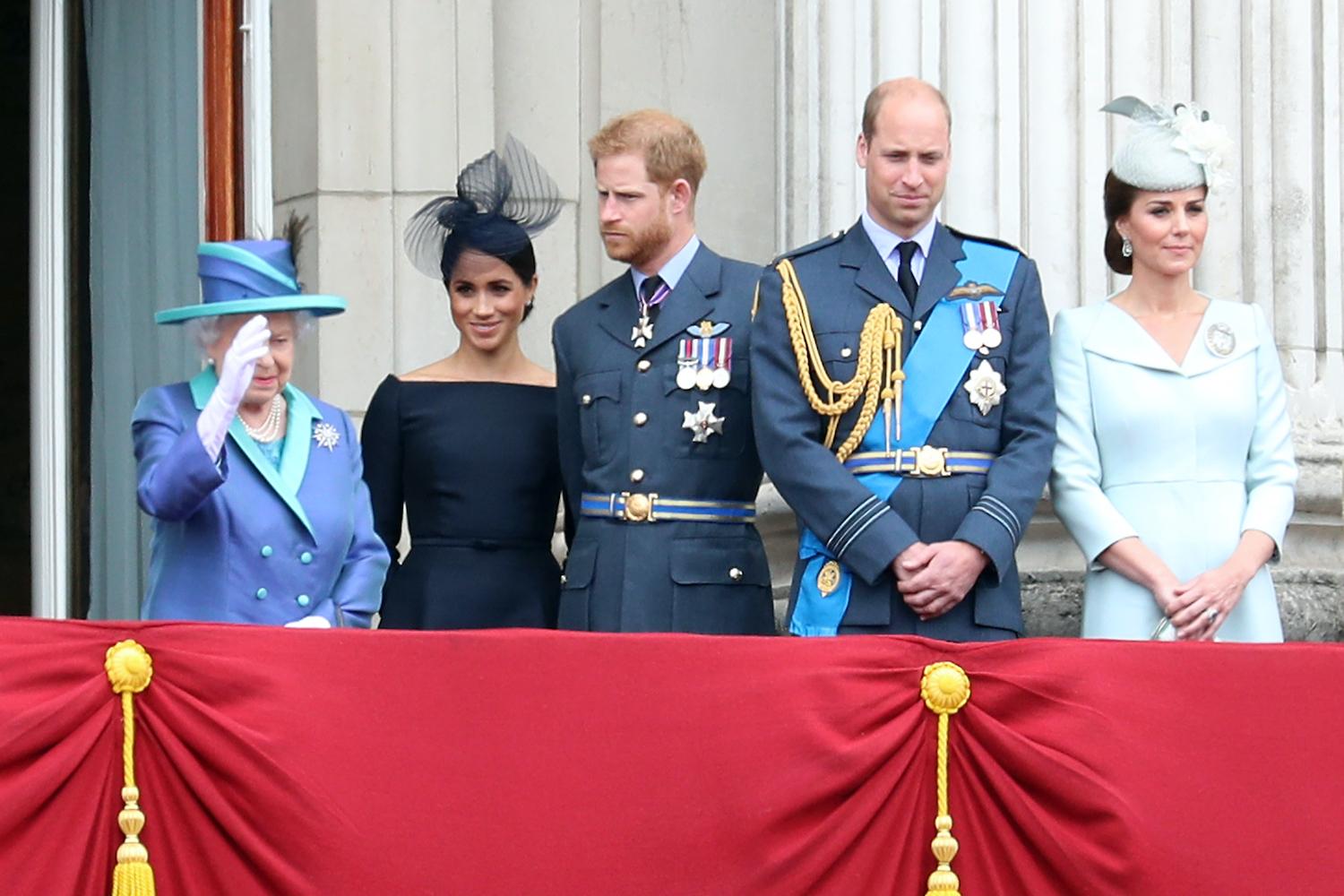 Queen Elizabeth II, Meghan Markle, Prince Harry, Prince William, and Kate Middleton watch the RAF flypast on the balcony of Buckingham Palace