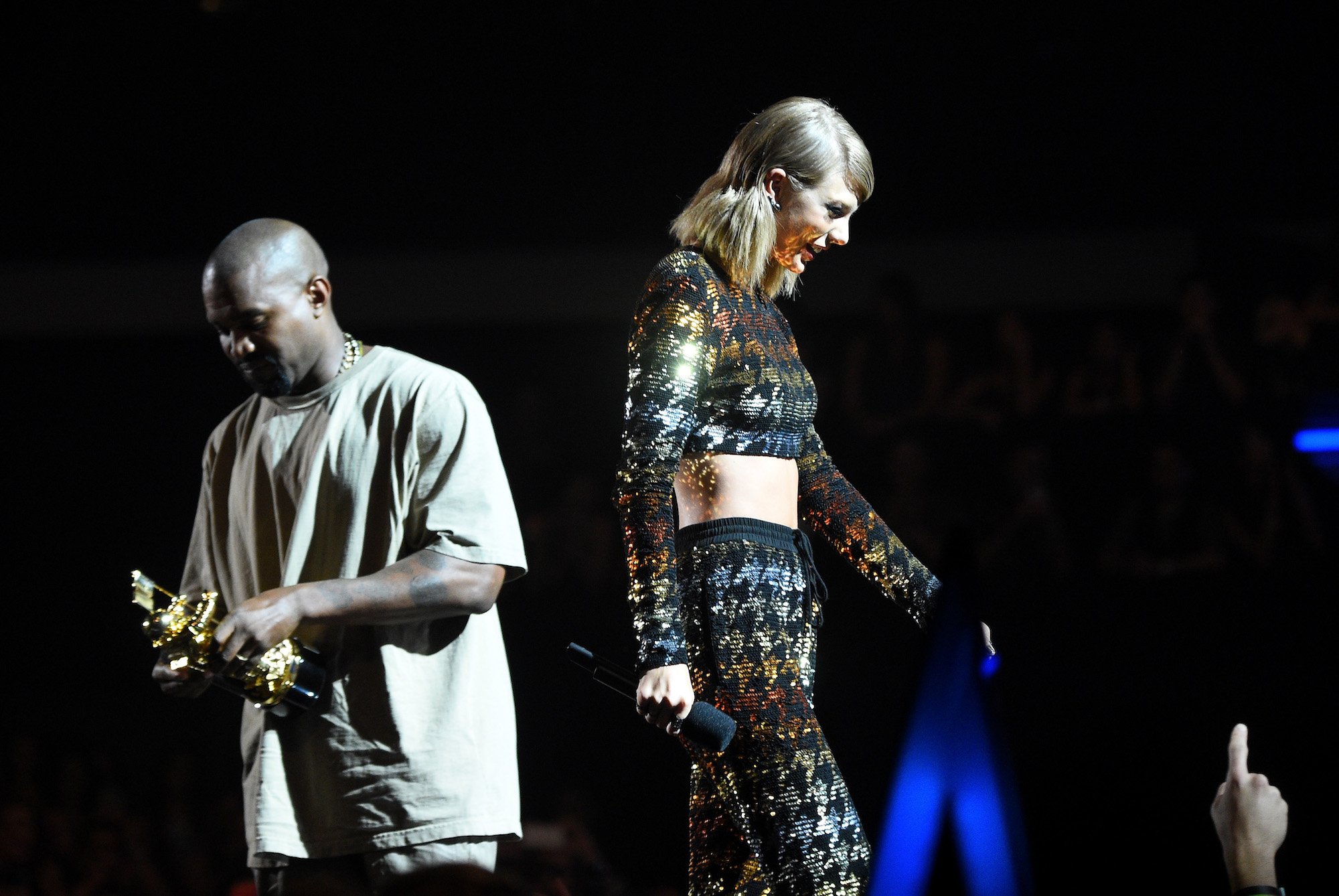 Kanye West accepts the Vanguard Award from recording artist Taylor Swift onstage during the 2015 MTV Video Music Awards.