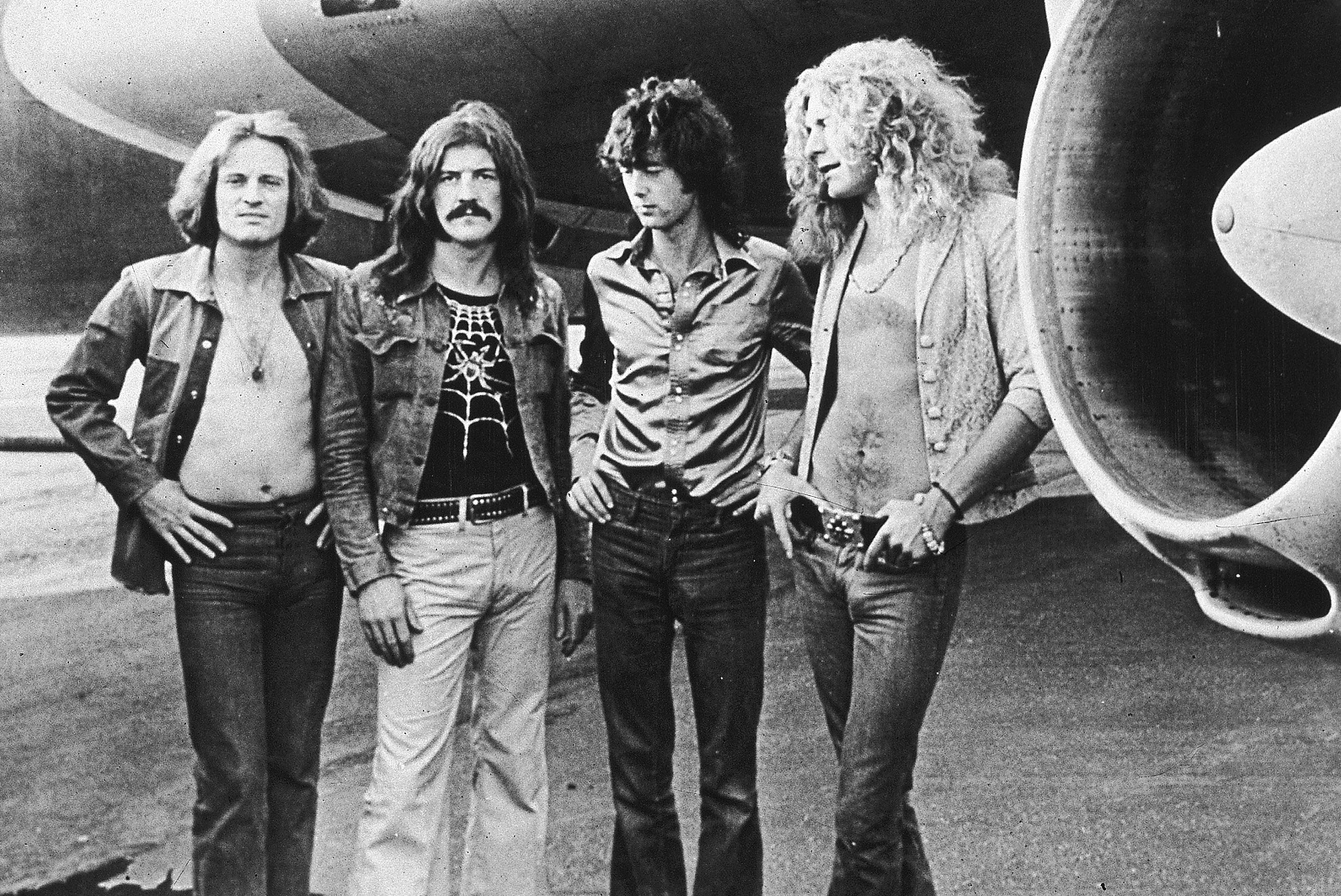 Led Zeppelin posed in front of Starship airplane