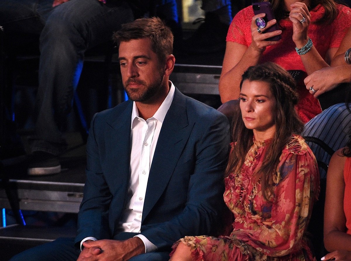 Aaron Rodgers and Danica Patrick sitting in the Nickelodeon Kids Choice Awards in 2018