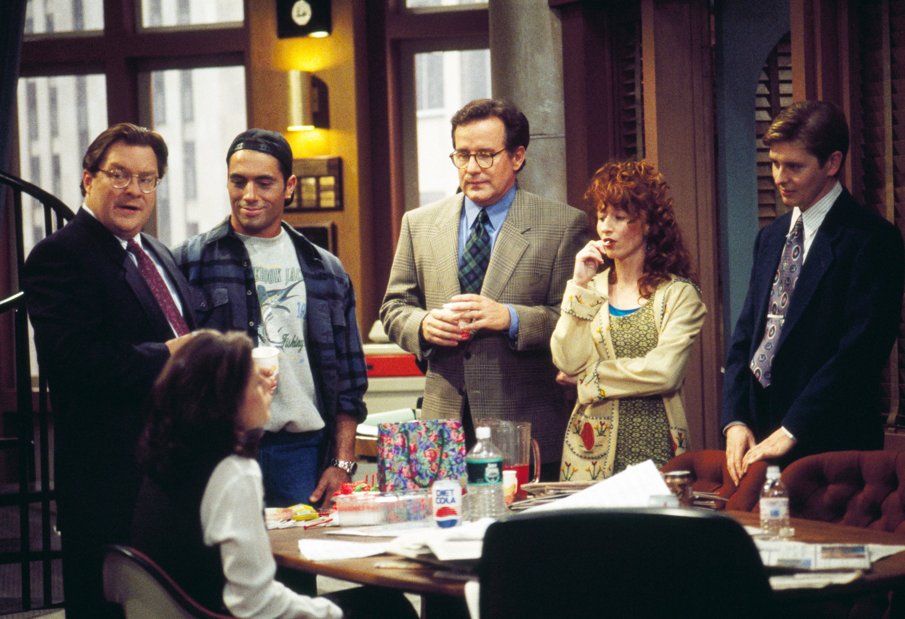 Cast of 'NewsRadio': (l-r) Stephen Root, Maura Tierney (seated), Joe Rogan, Phil Hartman, Vicki Lewis, and Dave Foley