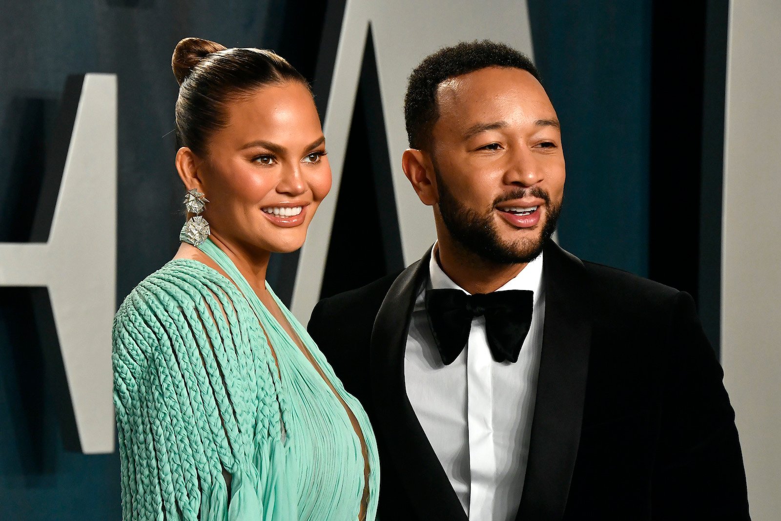 Chrissy Teigen and John Legend pose together at the 2020 Vanity Fair Oscar Party