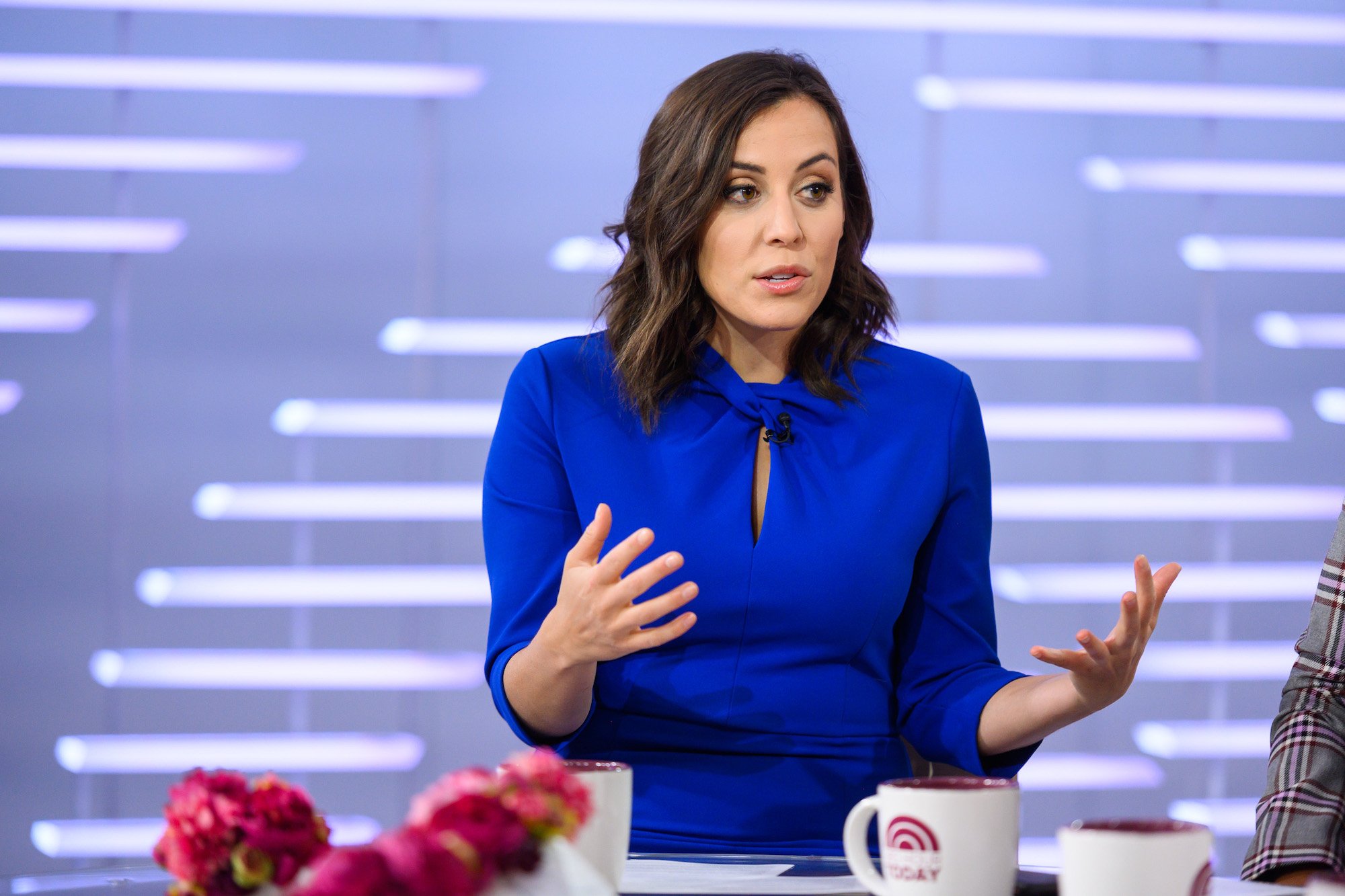 Hallie Jackson talking in front of a light blue background