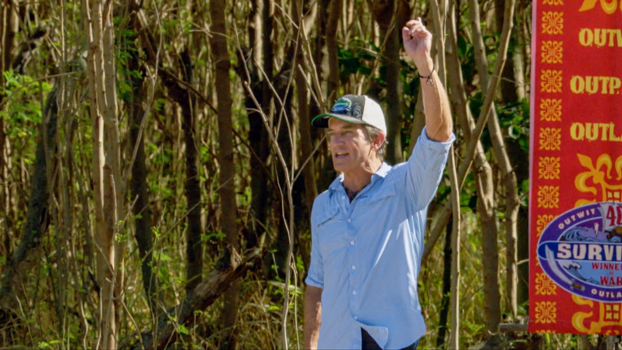 Jeff Probst on survivor with his arm raised