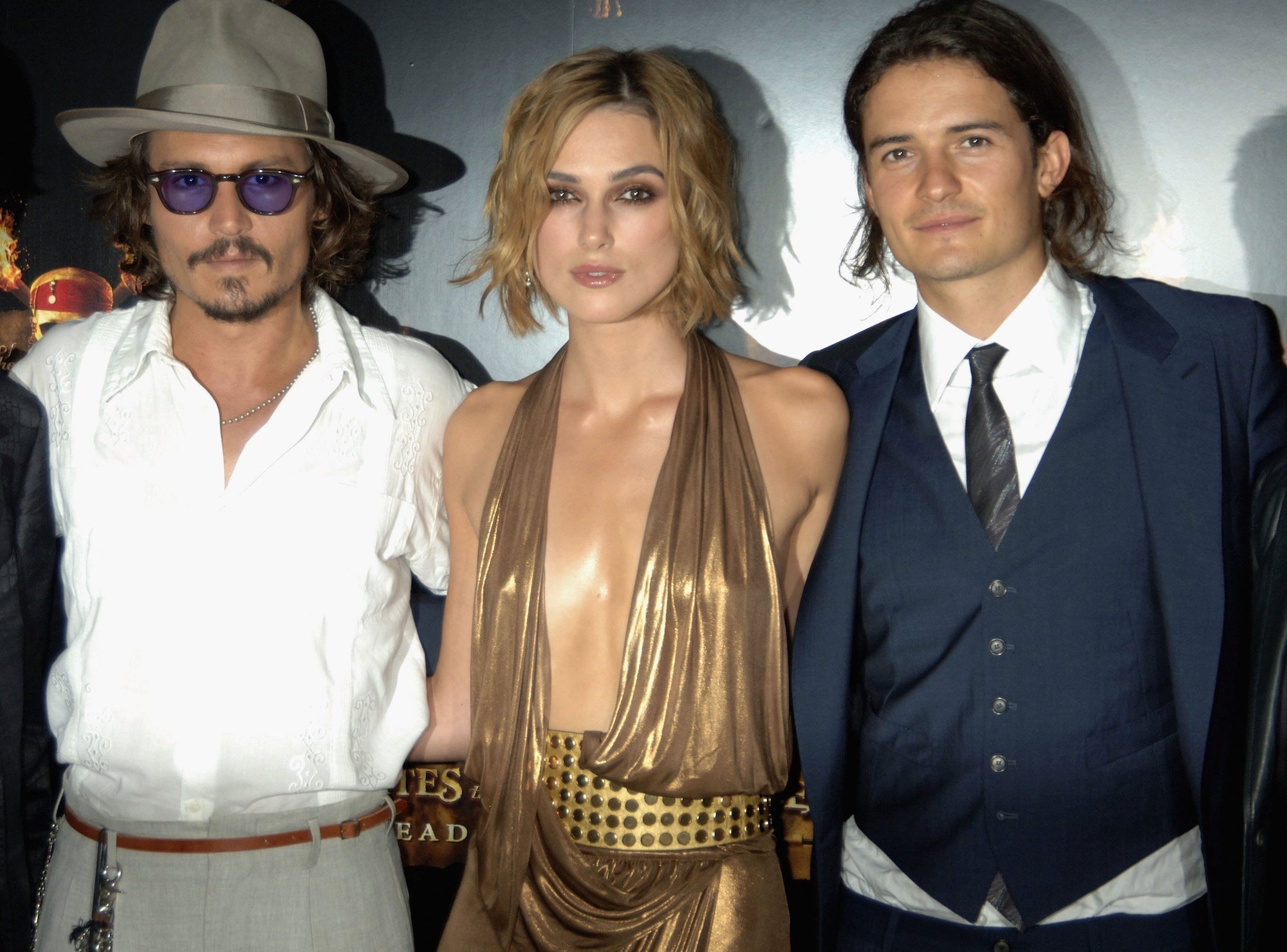 Johnny Depp, Keira Knightley, and Orlando Bloom smiling at the camera