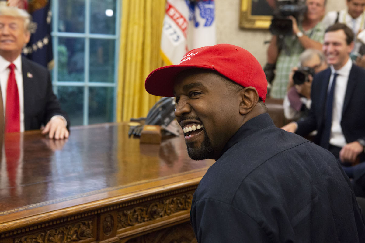 Kanye West laughs during a meeting with President Donald Trump in the Oval Office of the White House