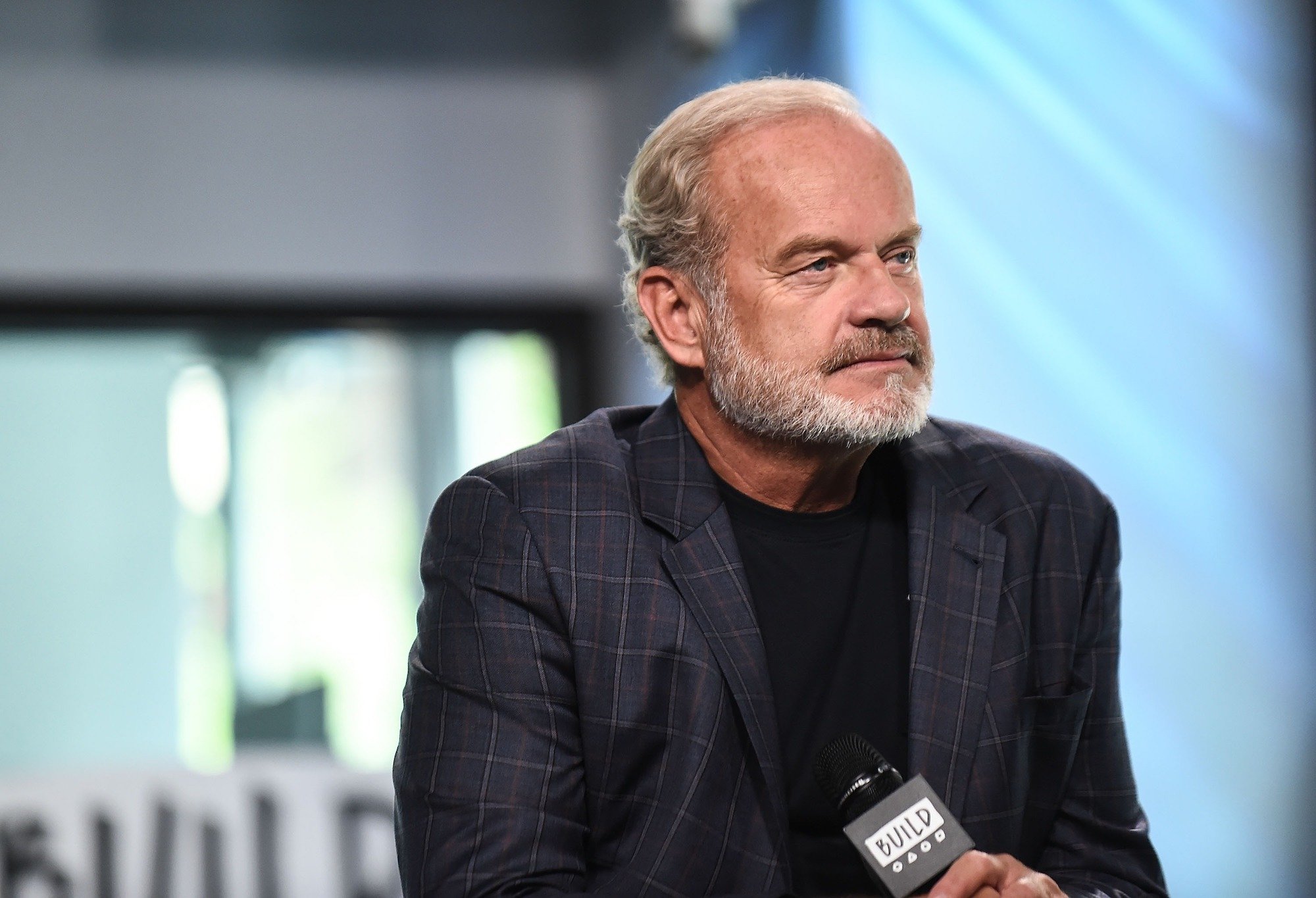 Kelsey Grammer slightly smiling looking off camera