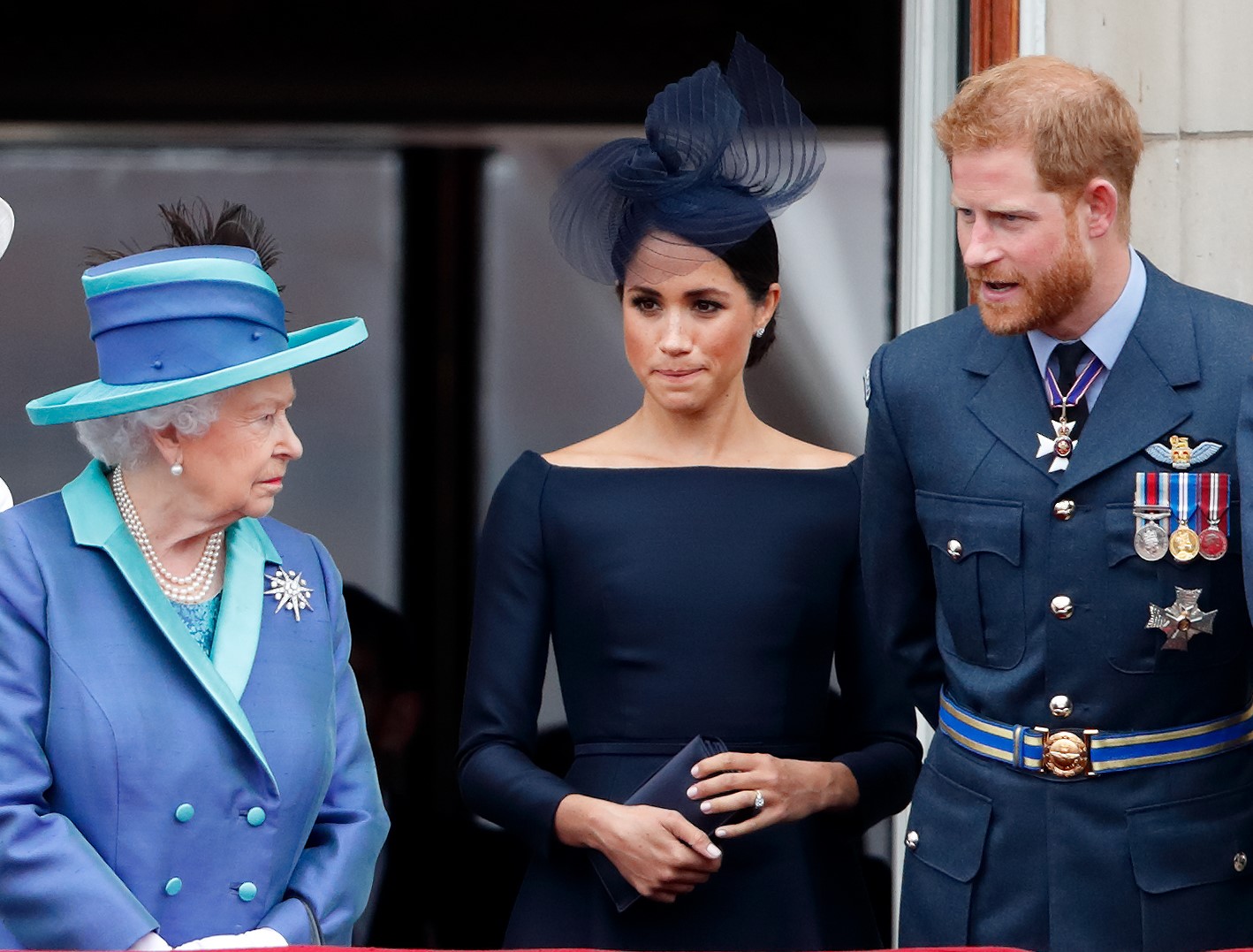(L to R) Queen Elizabeth II, Meghan Markle, and Prince Harry