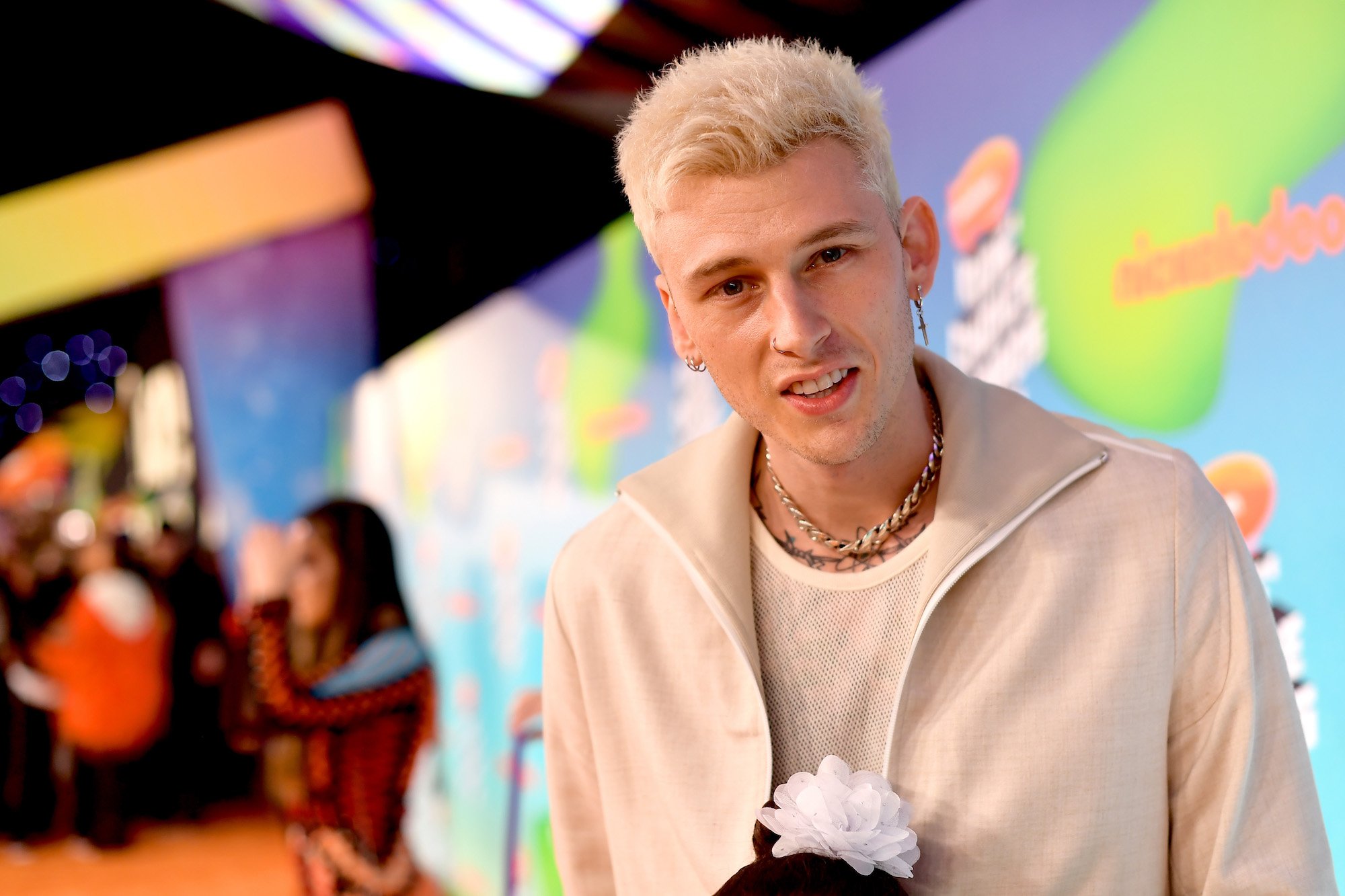 Machine Gun Kelly looking at the camera slightly smiling