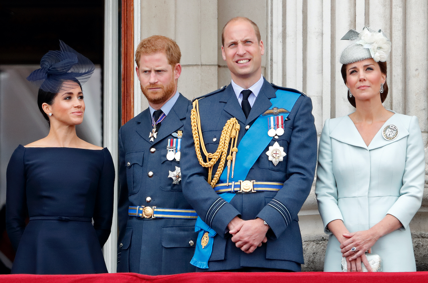 Meghan Markle, Prince Harry, Prince William, and Kate Middleton stand on the balcony of Buckingham Palace watching Royal Air Force flypast