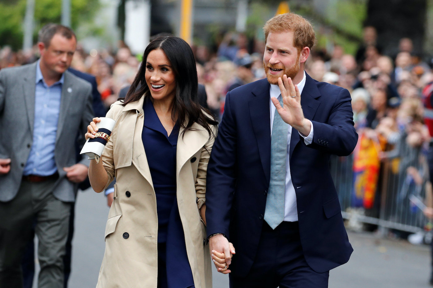 Meghan Markle and Prince Harry wave to crowds during a visit Australia in 2018