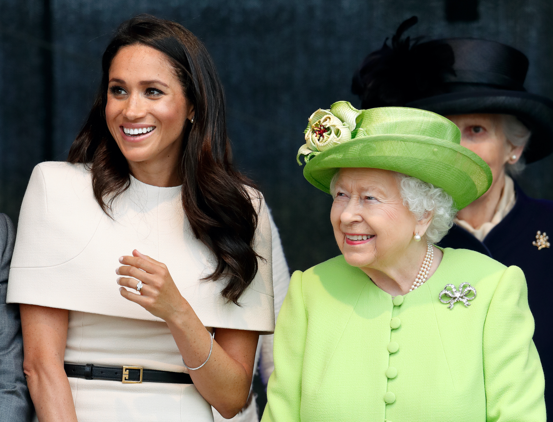 Meghan Markle and Queen Elizabeth II smile attending a ceremony to open the Mersey Gateway Bridge