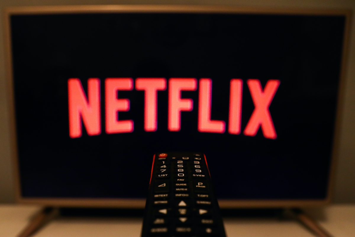 Netflix logo is seen displayed on TV screen