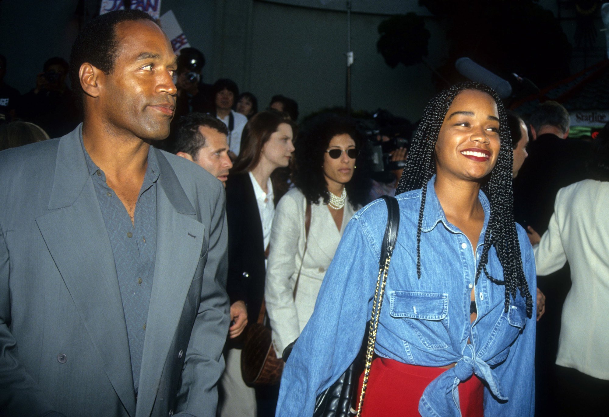 O.J. Simpson looking to the side and smiling with Arnelle Simpson smiling, looking off camera