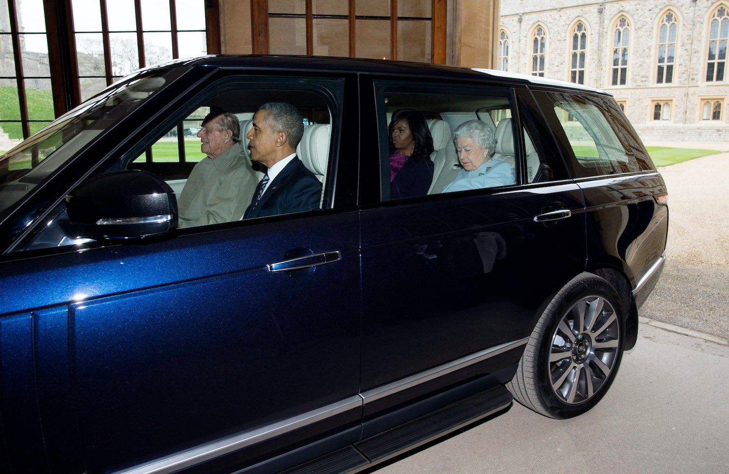 Prince Philip and Barack Obama ride in the front seat of a Range Rover while Queen Elizabeth II and Michelle Obama ride in the back seat
