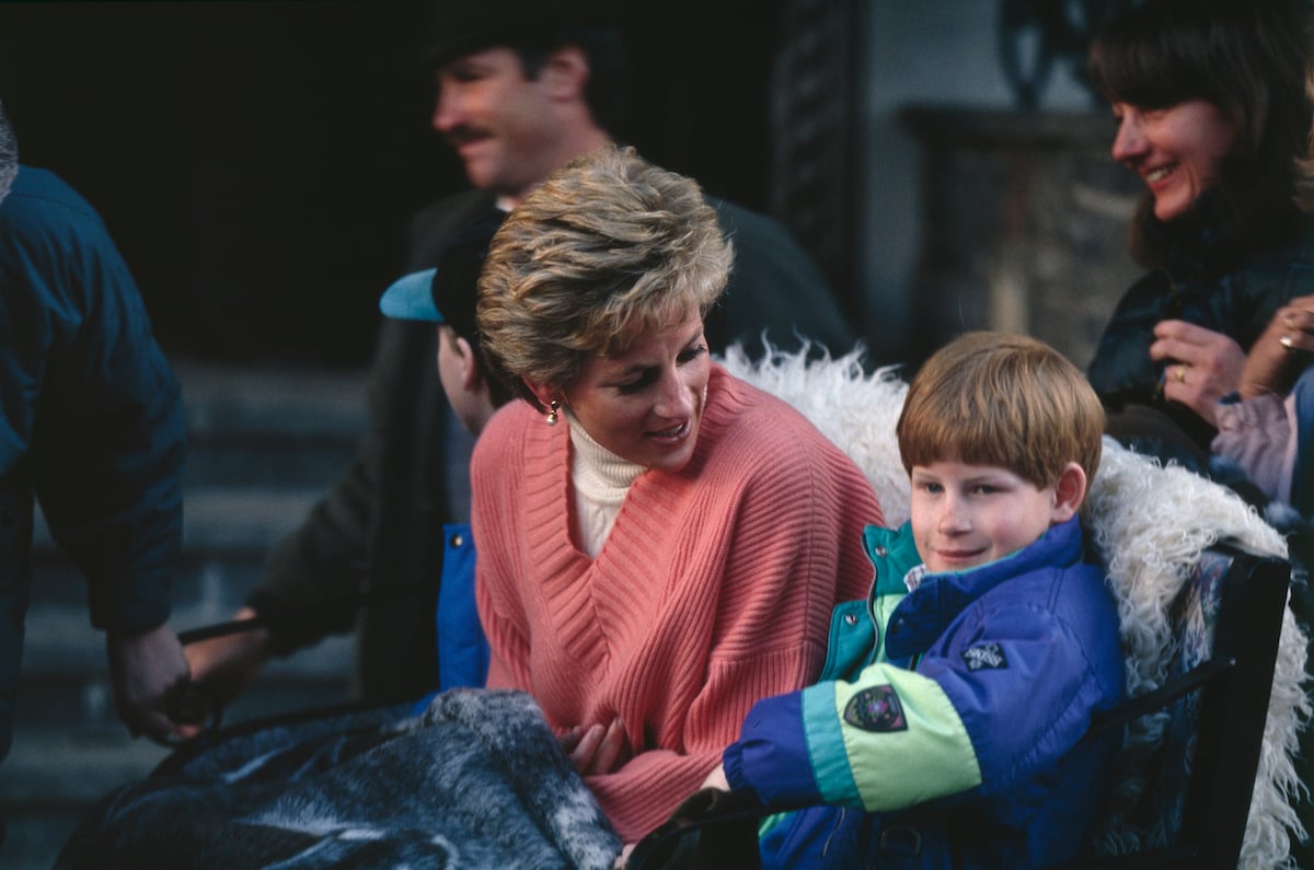 Princess Diana (1961 - 1997) and her sons Prince Harry and Prince William (in cap behind his mother) prepare to take a ride in a horse-drawn sleigh during a holiday in the Austrian resort of Lech, 27th March 1994