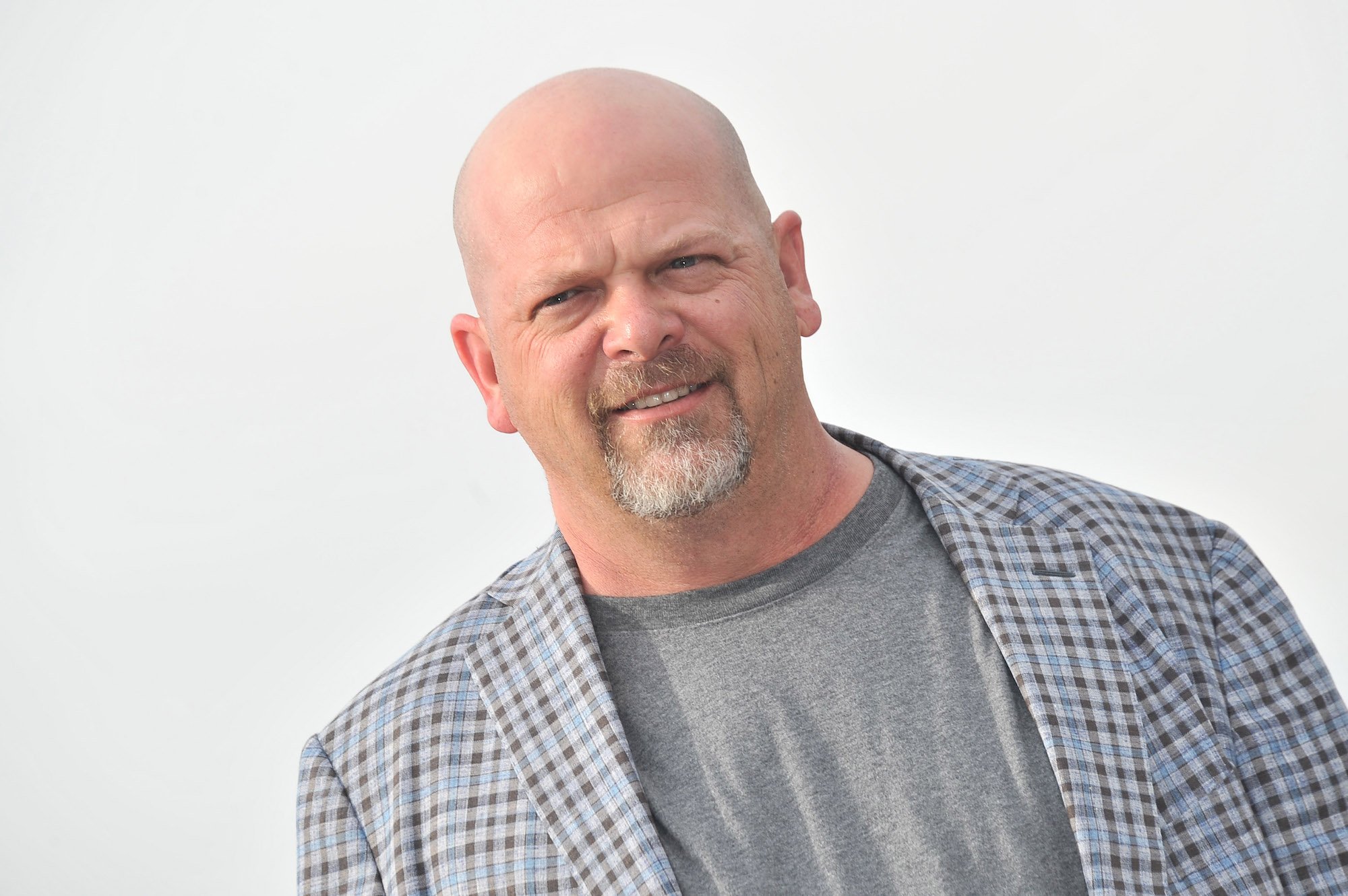 Rick Harrison smiling in front of a white background