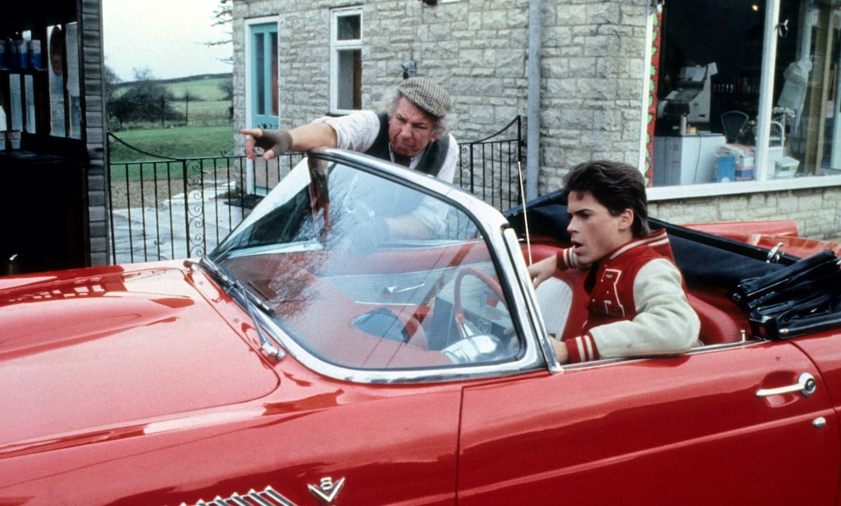 Rob Lowe getting directions in his convertible in a scene from the film 'Oxford Blues'