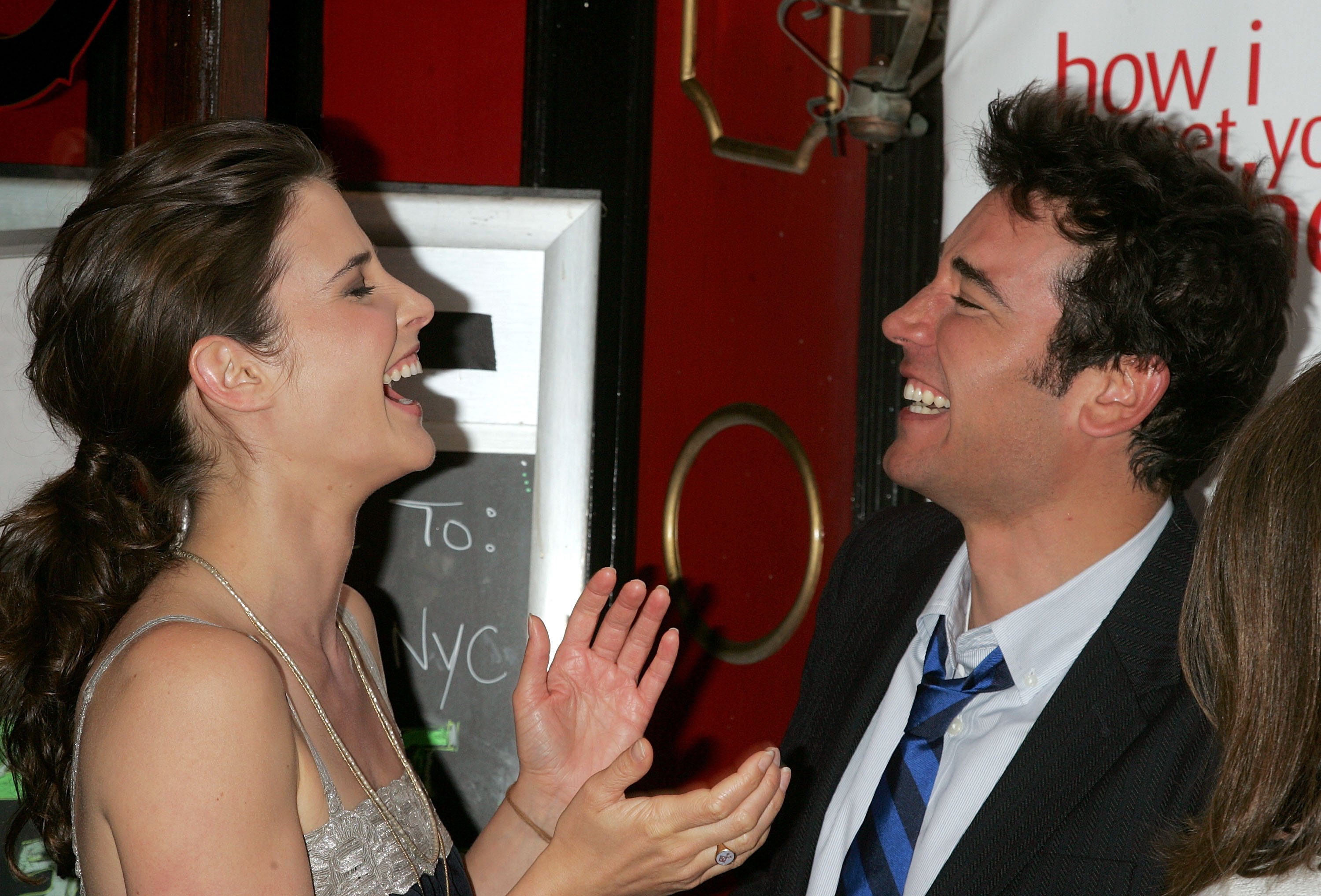 Josh Radnor and Cobie Smulders laughing.