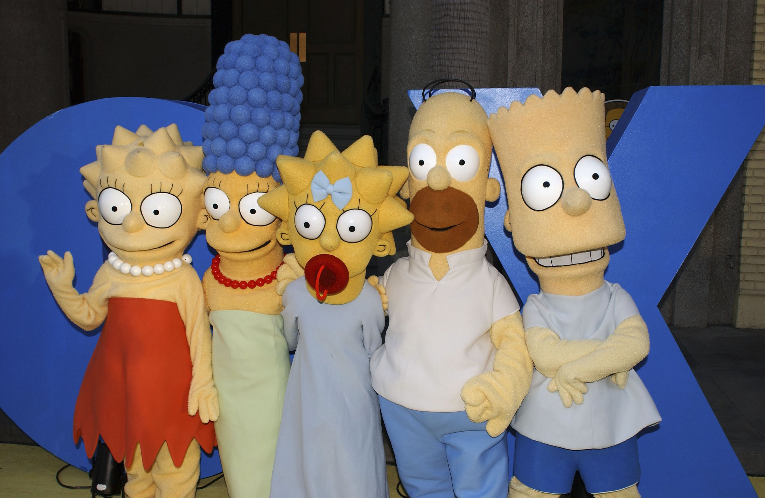 Lisa, Marge, Maggie, Homer and Bart Simpson pose for a photograph at "The Simpsons" 350th episode block party