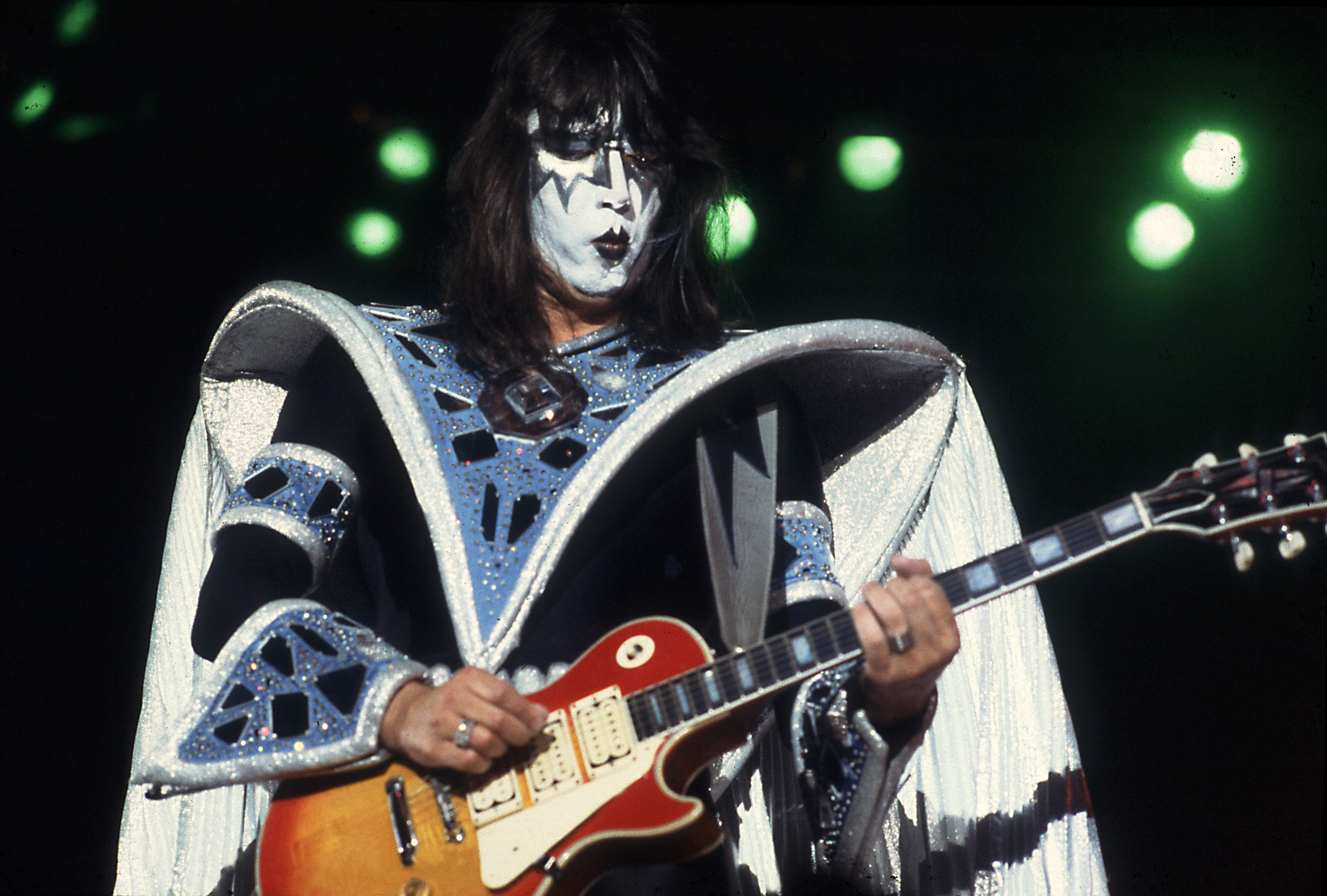 Ace Frehley of Kiss holding a guitar