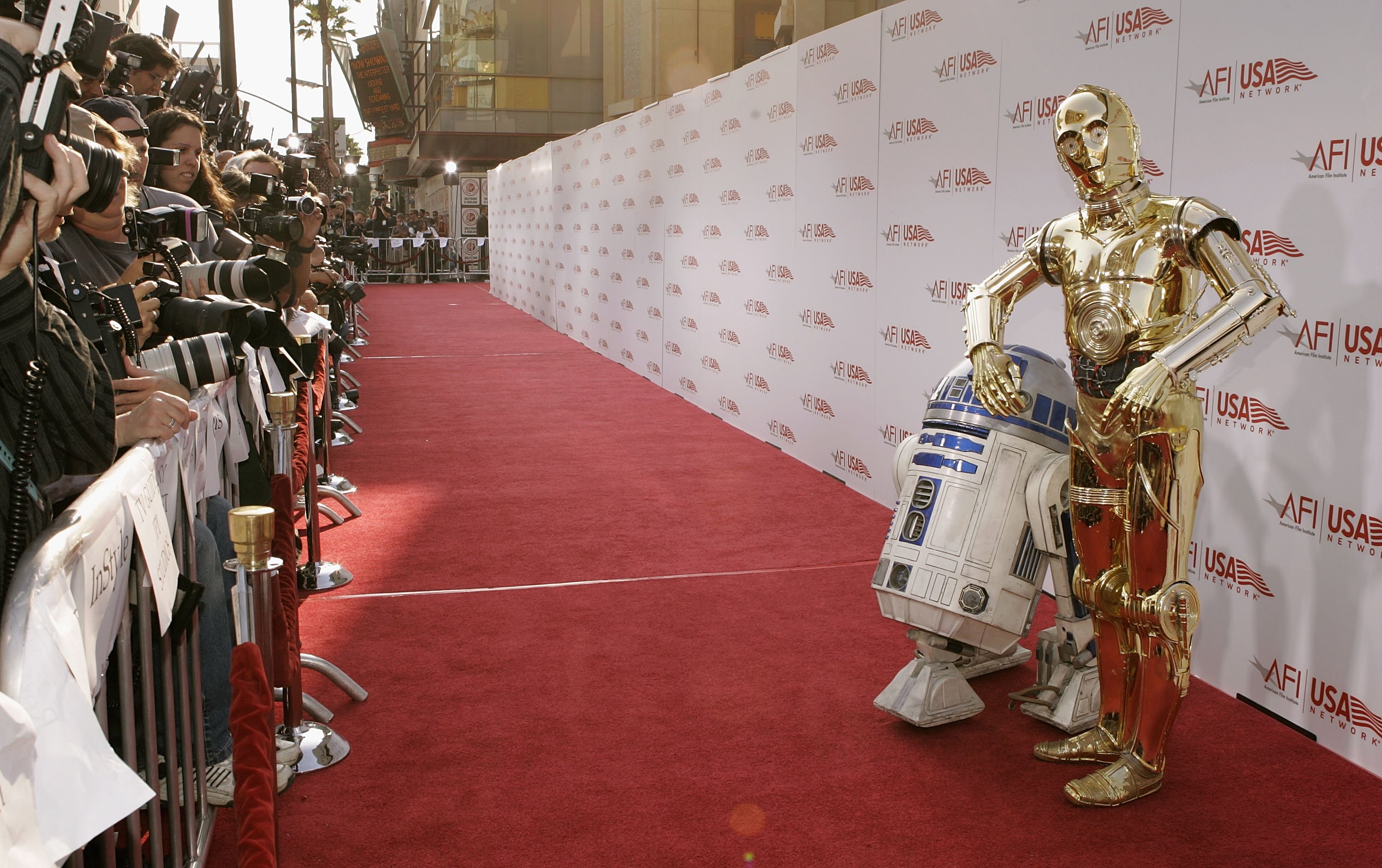 C-3PO and R2-D2 near photographers