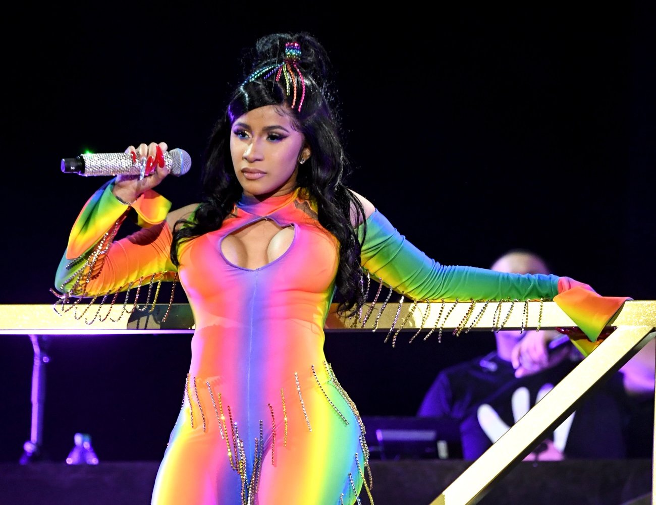 Cardi B OnlyFans is live but what is she doing there? In this pic, the rapper is wearing a rainbow onesie on stage.