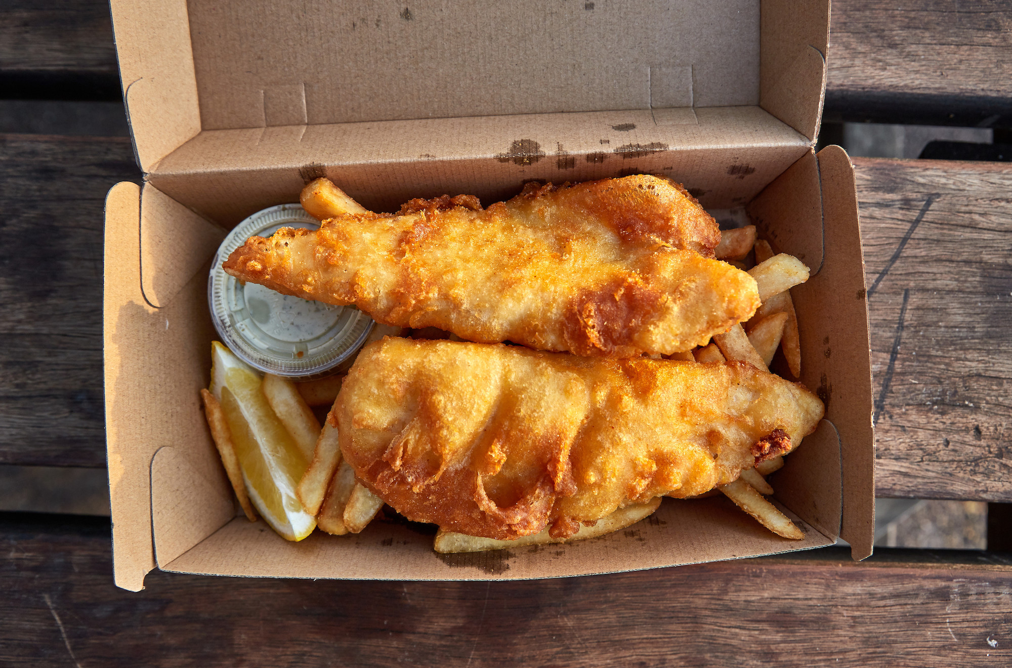 Fish and chips in a cardboard box.