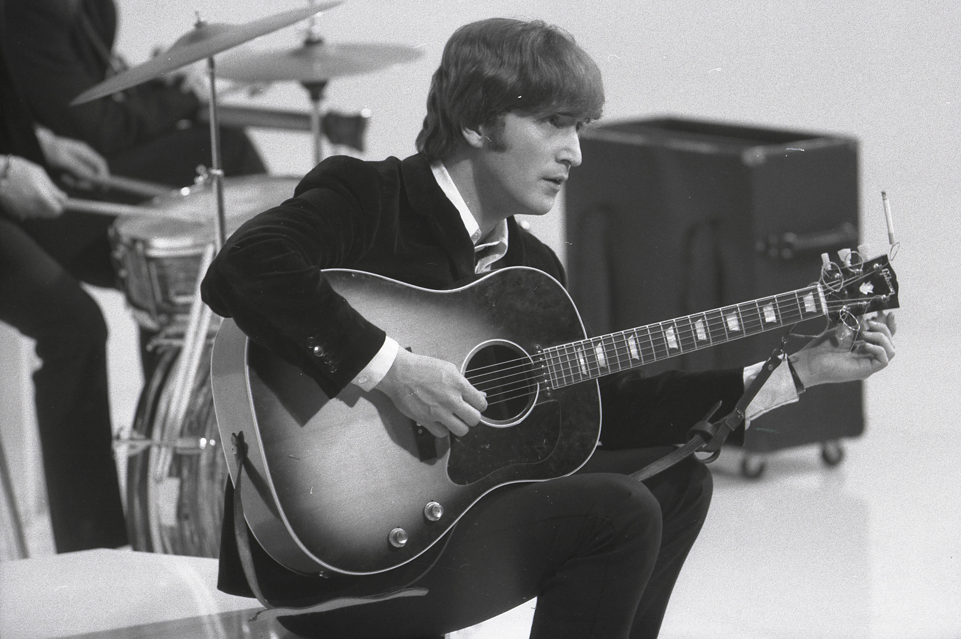 John Lennon holding his guitar