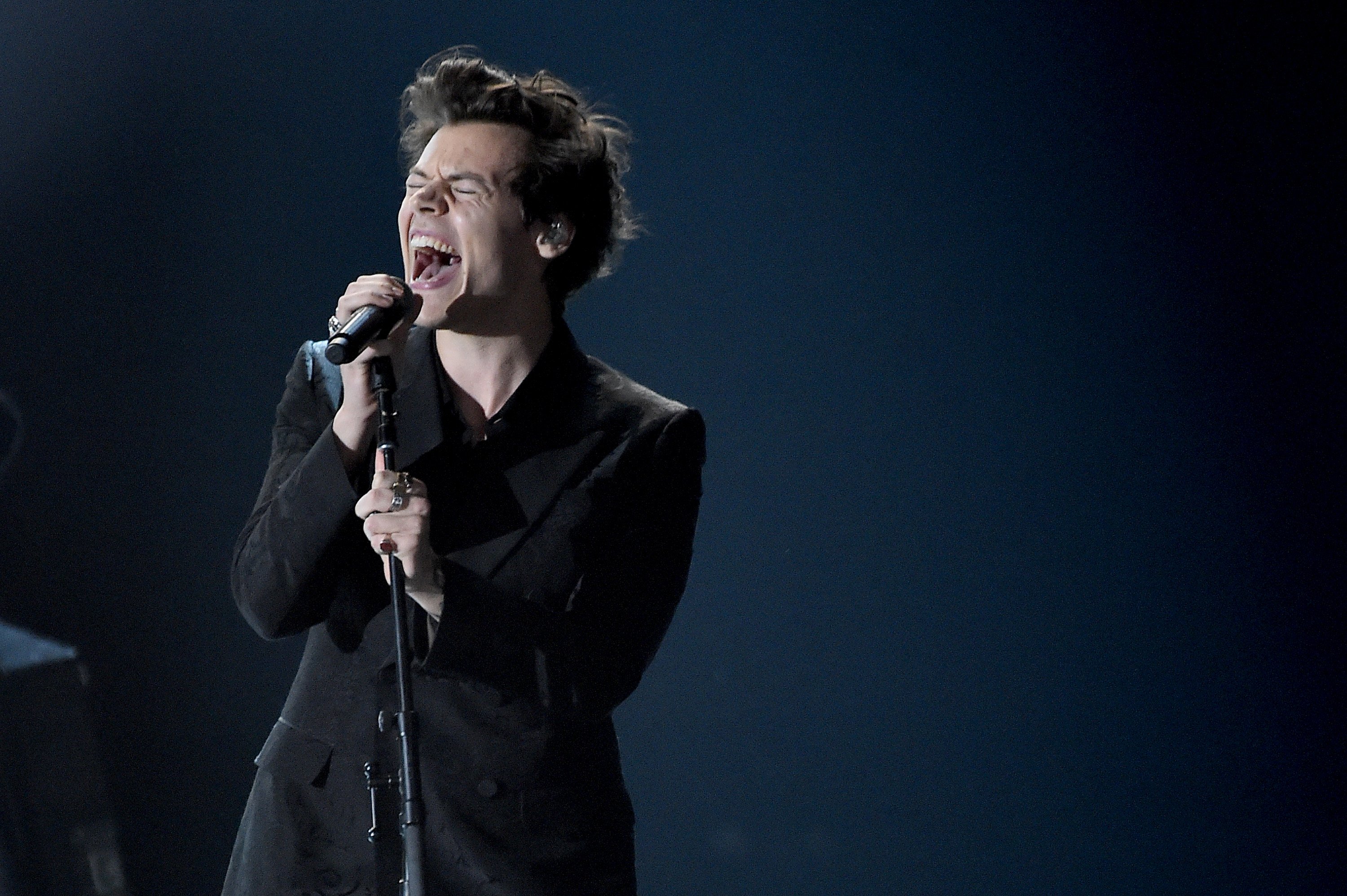 Harry Styles singing into a microphone