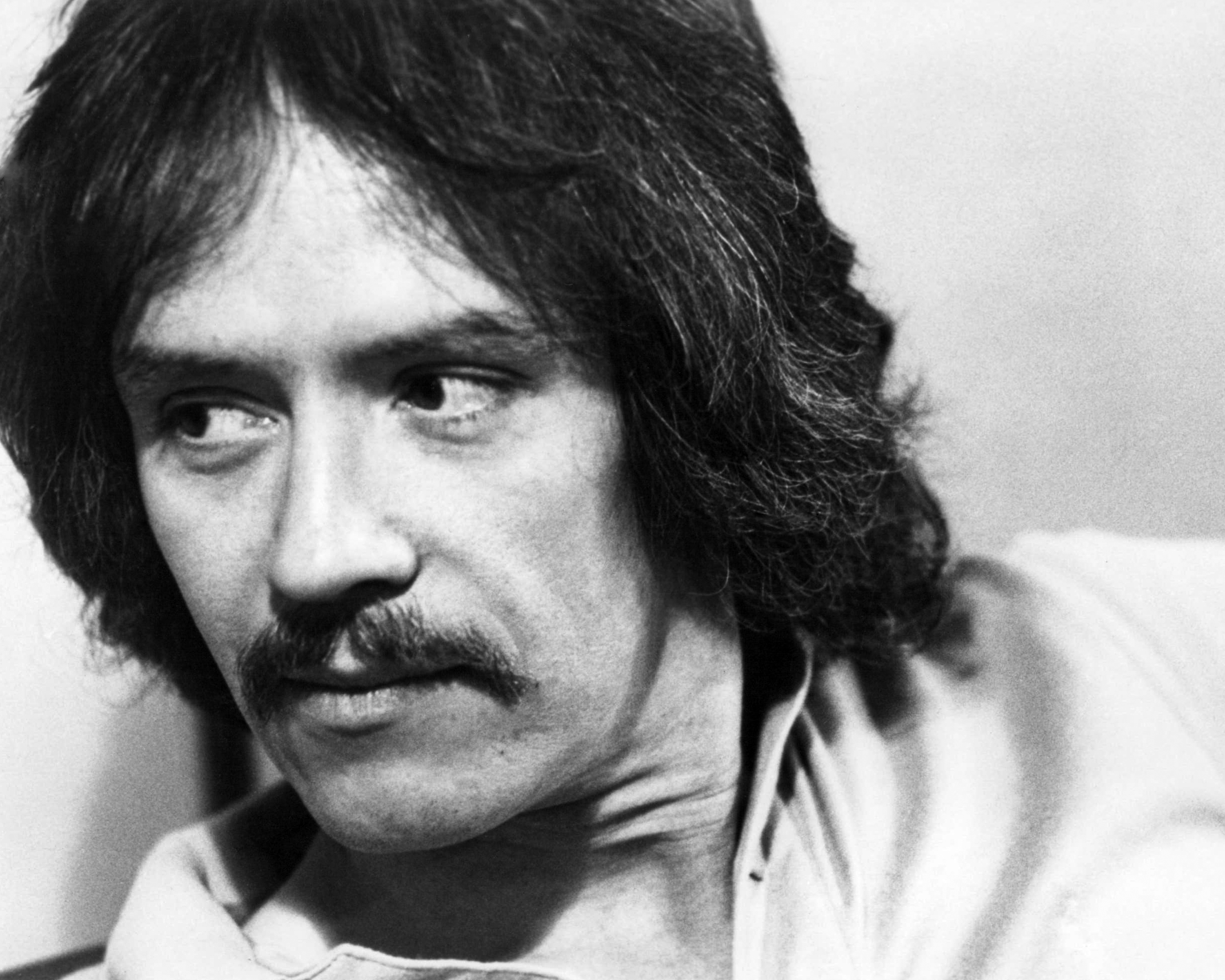 A closeup of John Carpenter with a mustache
