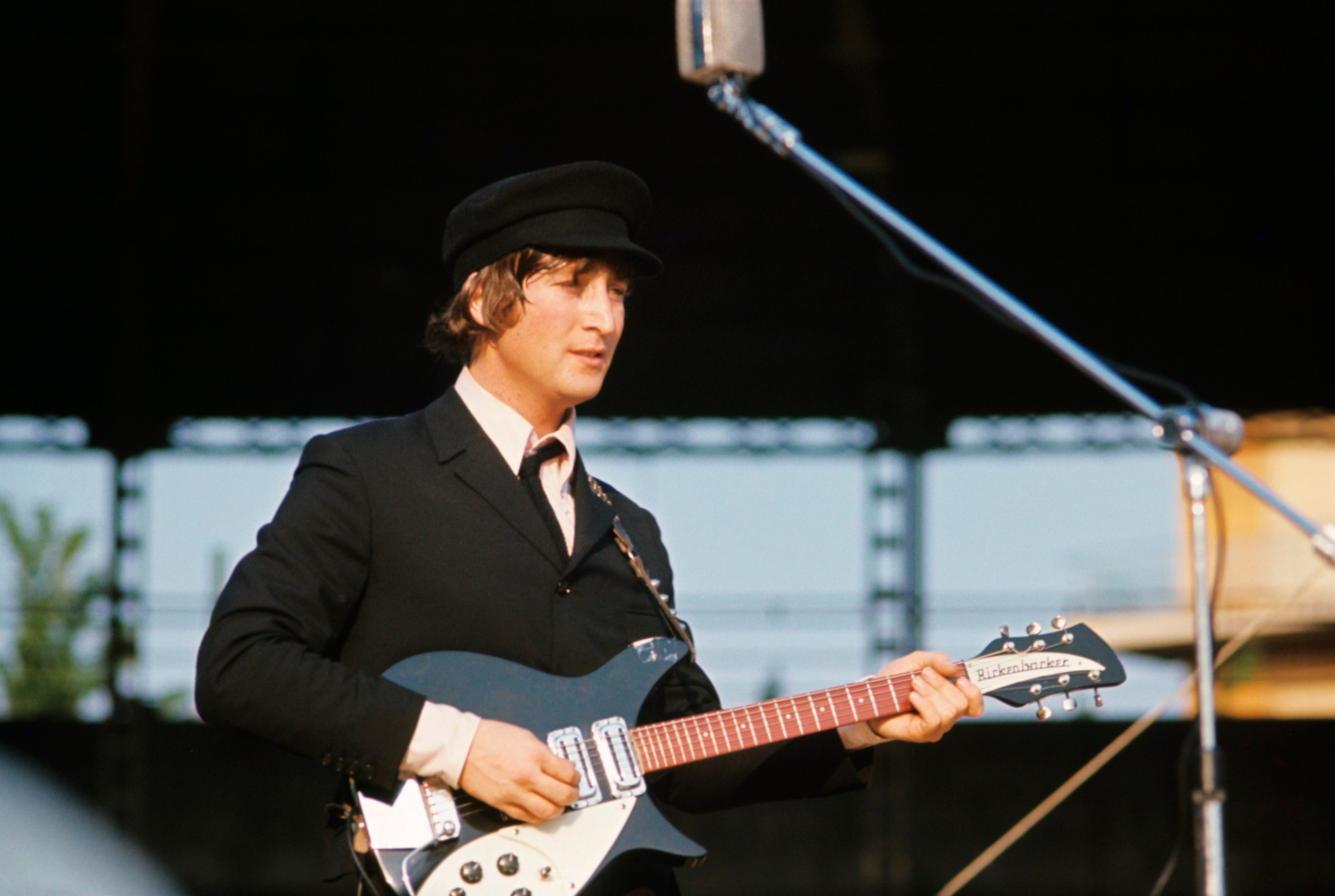 John Lennon holding a blue guitar