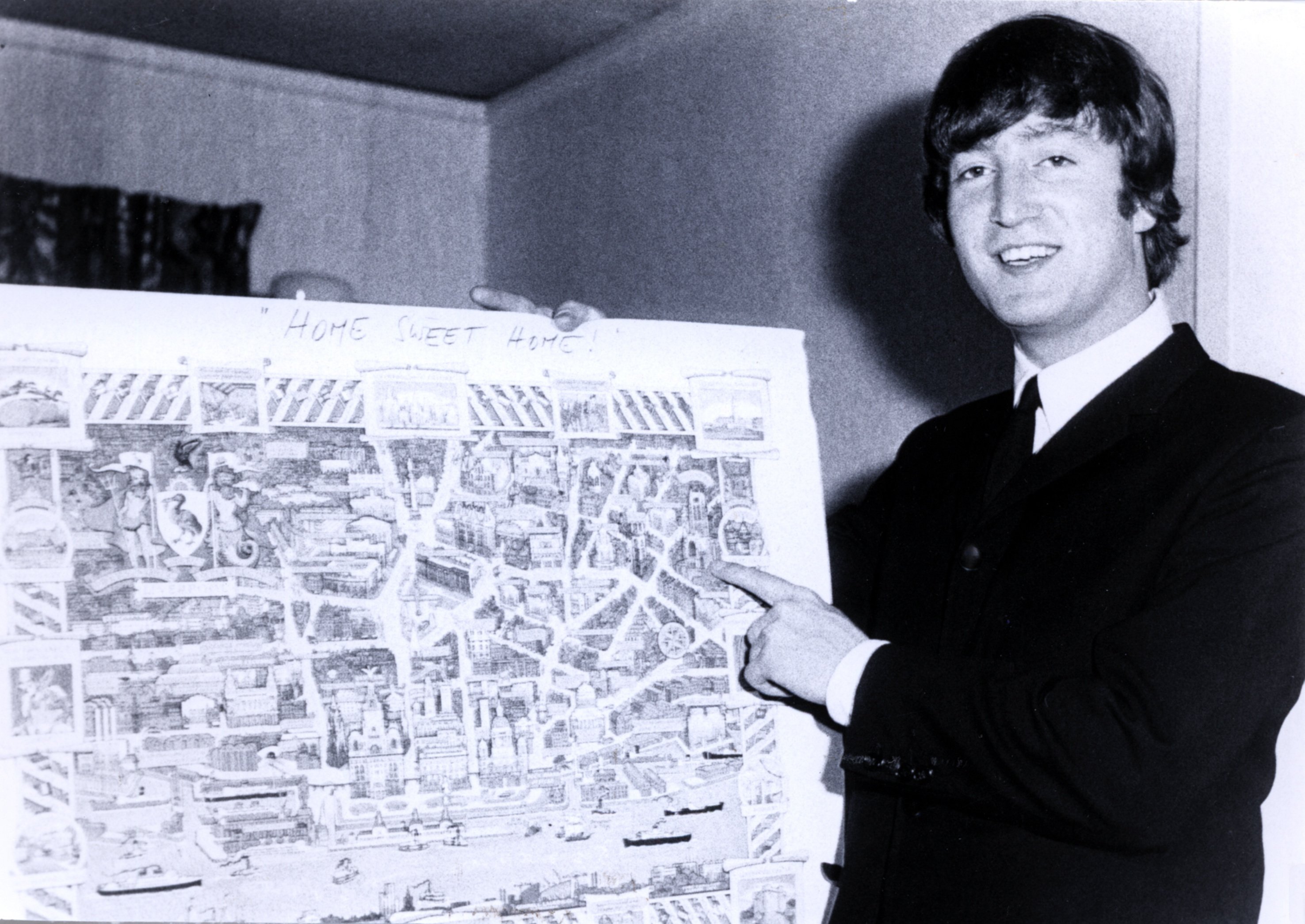 John Lennon with a map