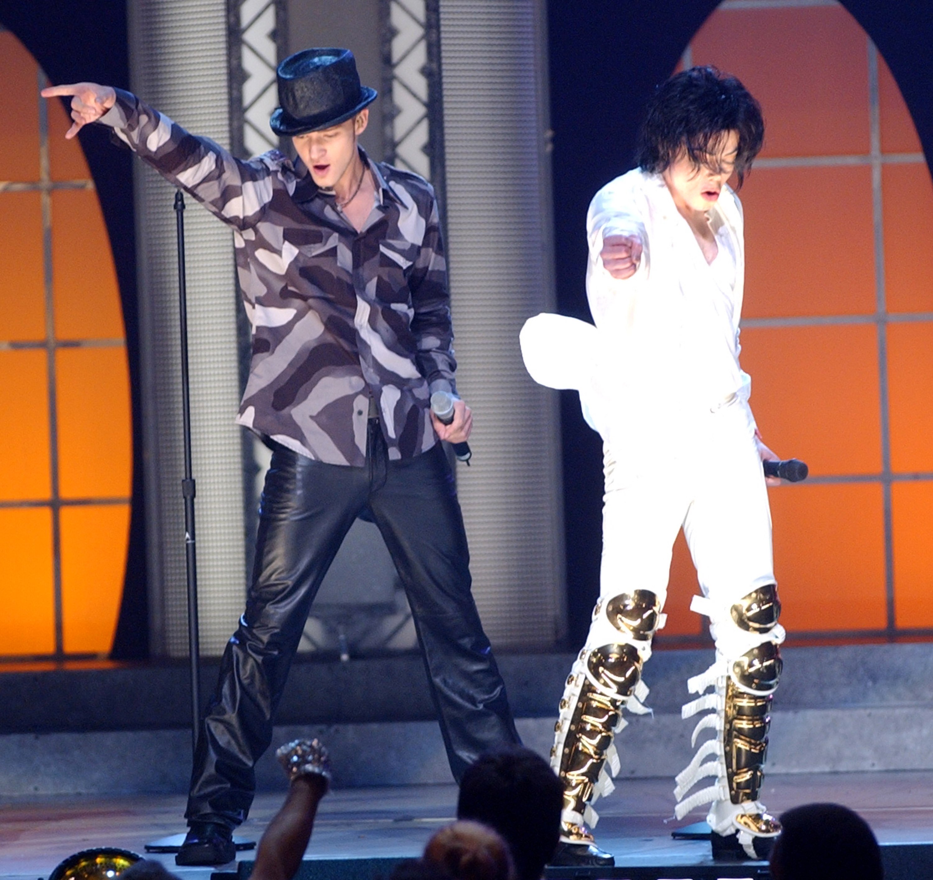 Justin Timberlake and Michael Jackson raising their arms