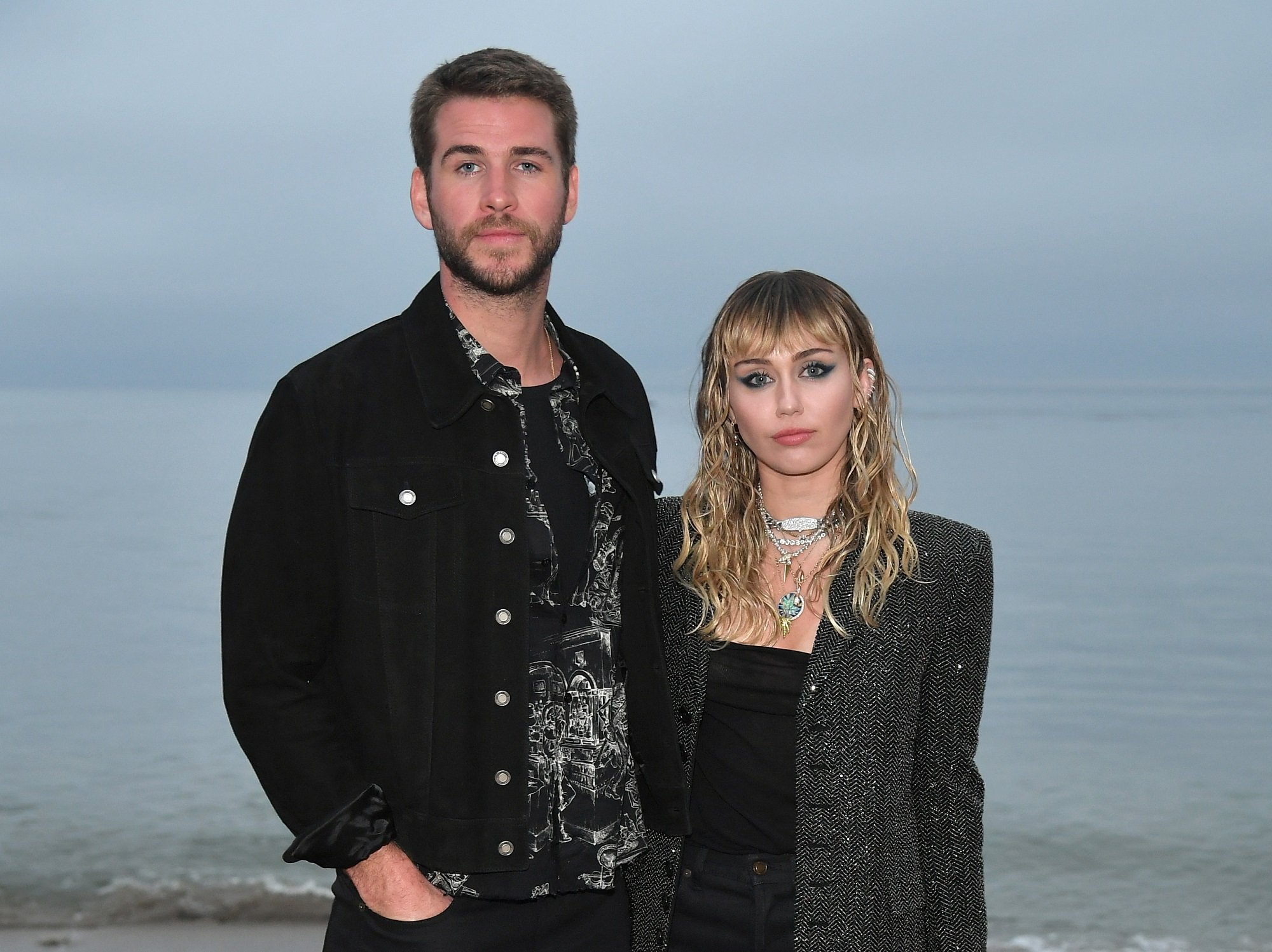 (L-R) Liam Hemsworth and Miley Cyrus attend the Saint Laurent Mens Spring Summer 20 Show Photo Call on June 06, 2019 in Malibu, California.