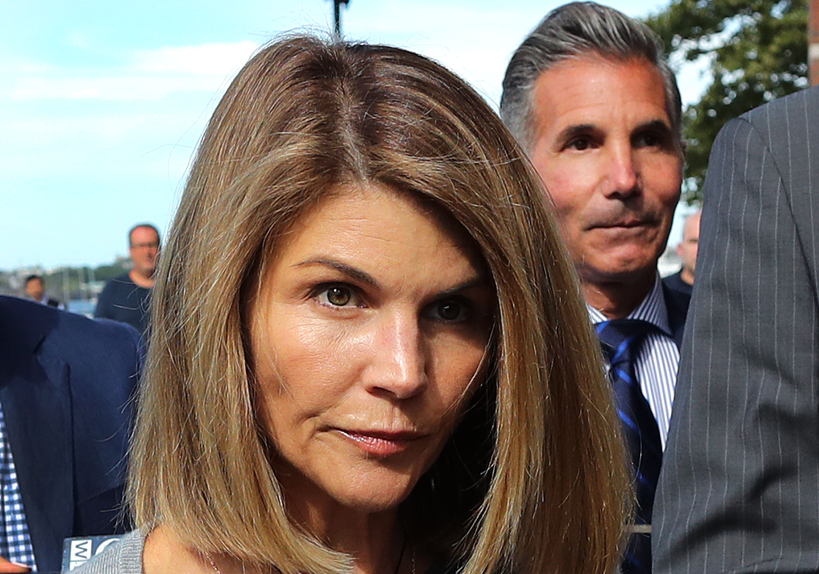 Lori Loughlin, with Mossimo Giannulli behind her