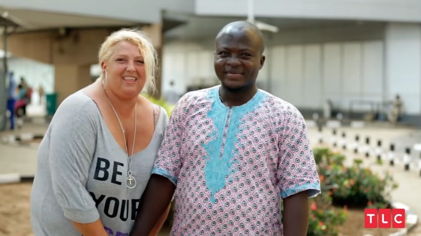 90 Day Fiancé couple Angela and Michael -- Angela Deem is holding Michael Ilesanmi's hand