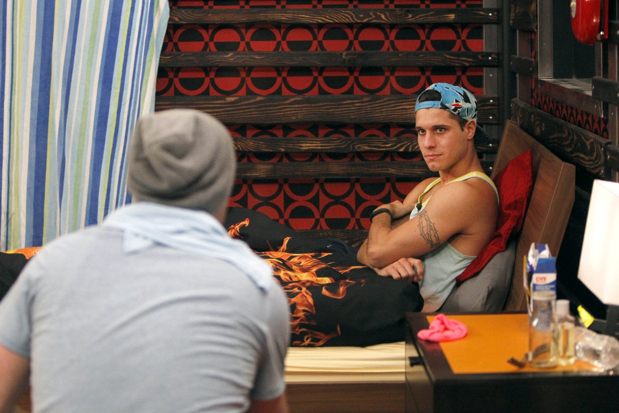 Houseguests Cody Calafiore and Derrick Levasseur chat in the fire room, on Big Brother