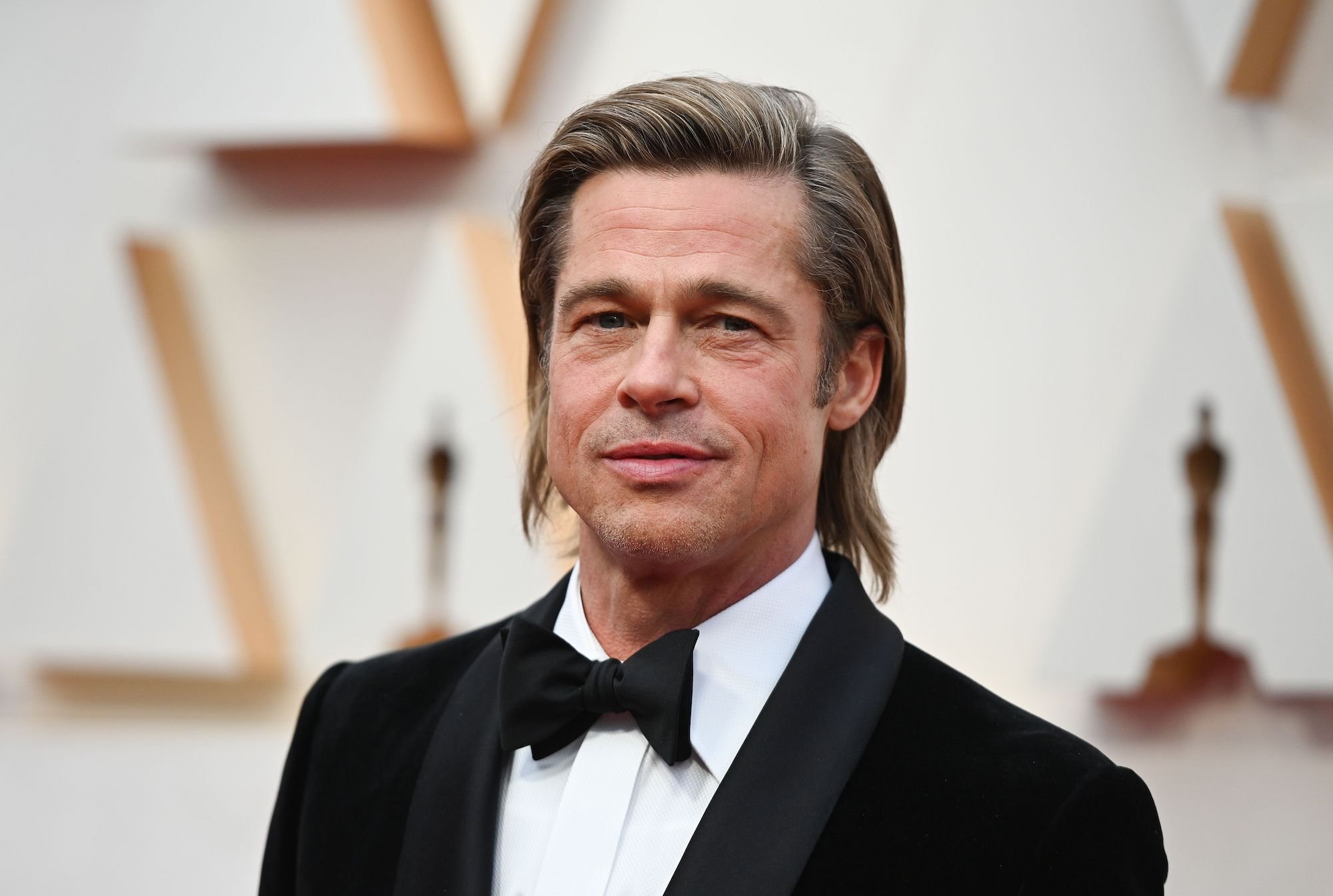 Brad Pitt smiling, turned slightly to the side